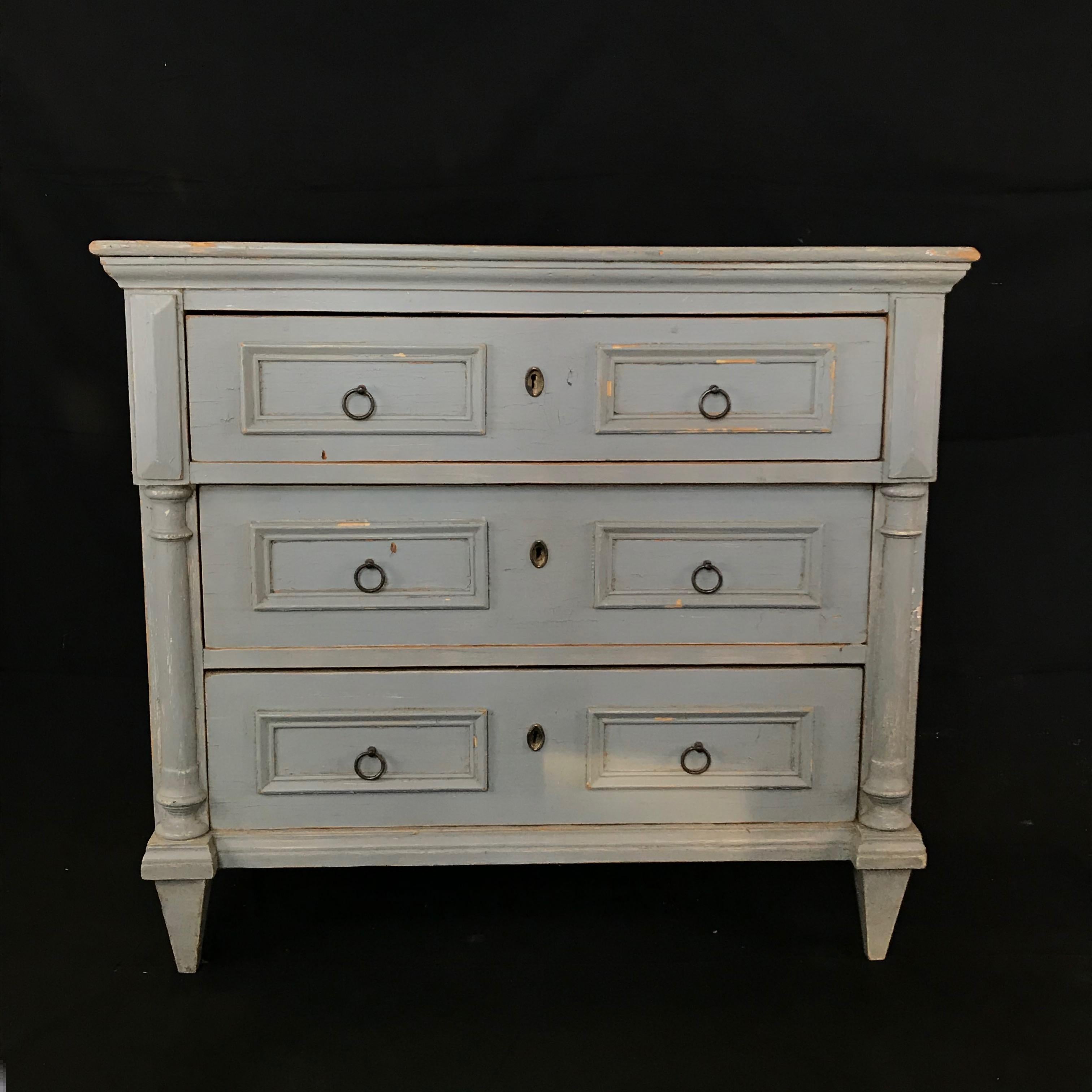 Chest of drawers in the Gustavian style, Sweden, circa 1880, with three paneled drawers. Finely shaped top, carved corner posts over columns, and tapering square fluted feet. Period brass pulls and escutcheons. #4244