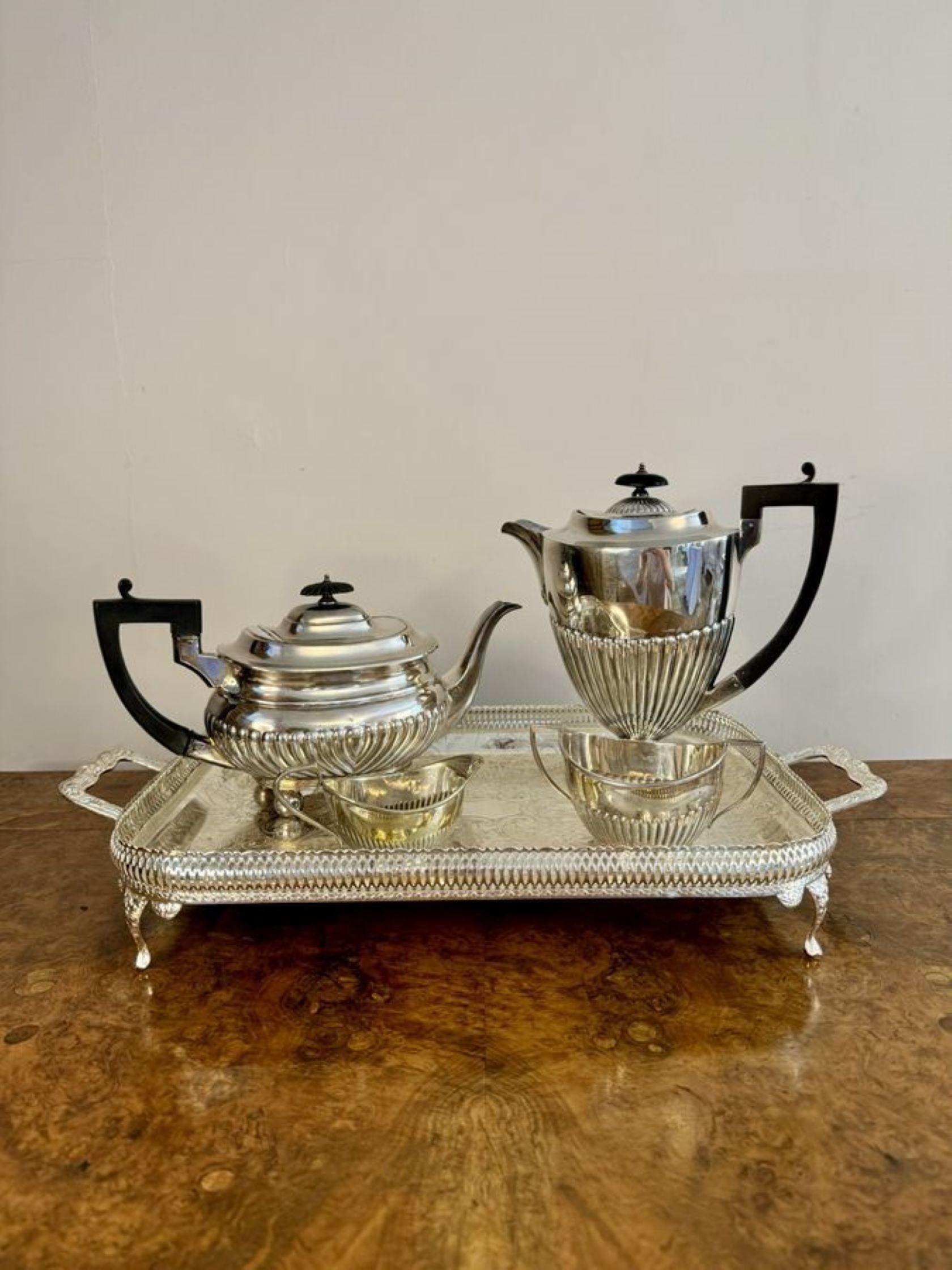Elegant antique Edwardian quality silver plated four piece tea set and tray, consisting of a coffee pot, tea pot, sugar bowl and a milk jug with shaped handles and spouts with an accompanying ornate detailed tea tray with twin handles to the sides