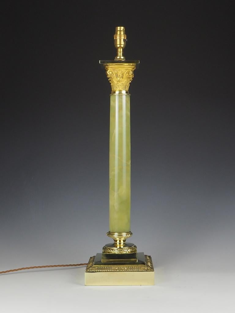 Antique Oynx and Brass Corinthian Table Lamp is a truly remarkable piece that exudes elegance and sophistication.

With its very large size and exceptional quality, it is sure to make a statement.

This lamp has been a recent purchase from a large