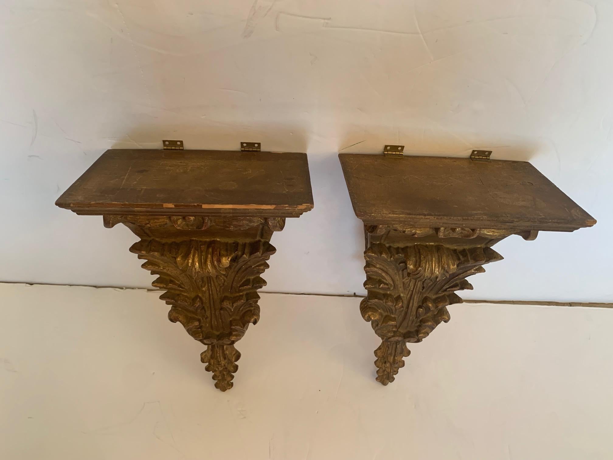 Superbly elegant pair of French antique carved and gilded wood wall brackets adorned with acanthus leaves.