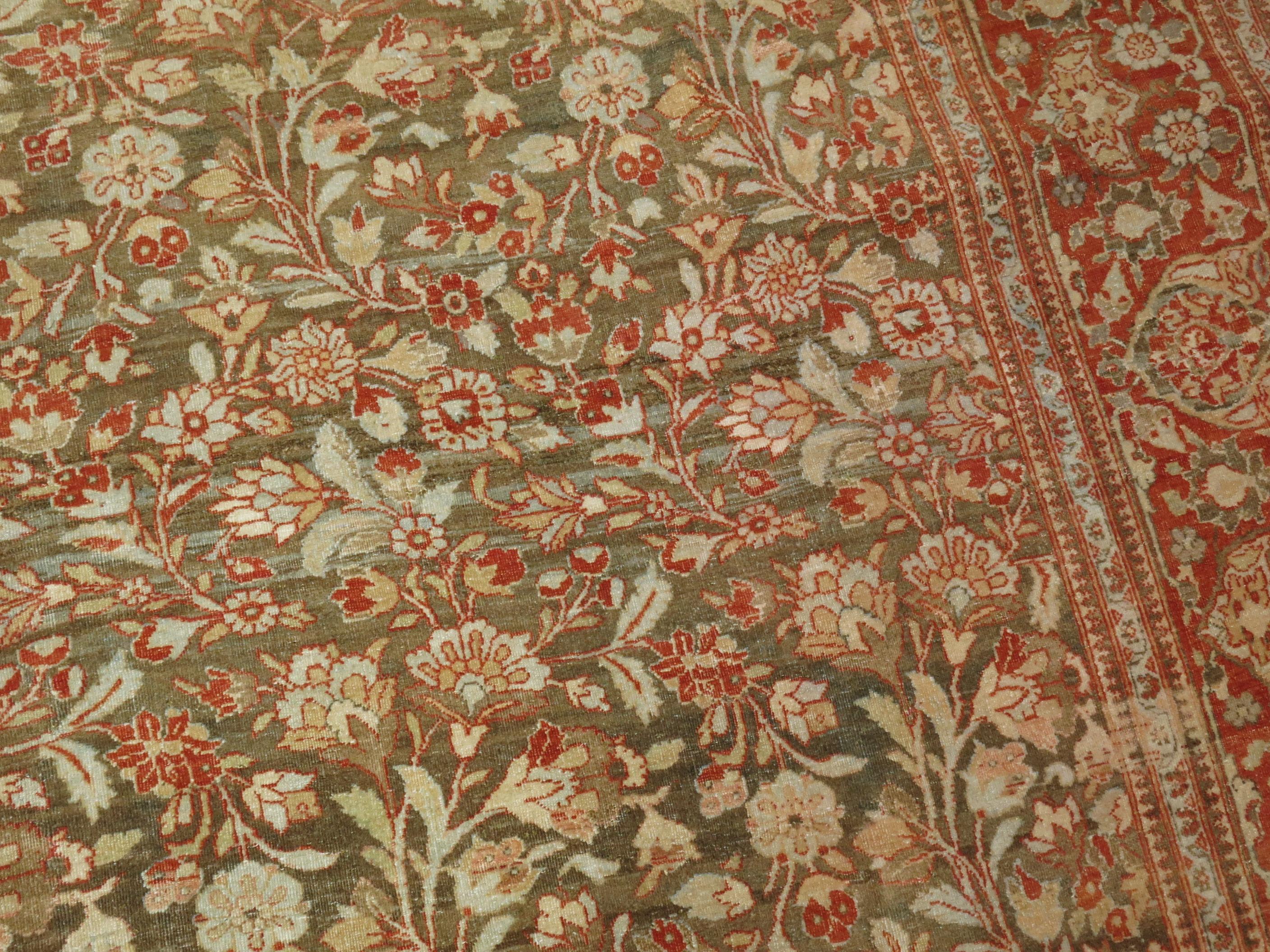 An early 20th century Persian Tabriz rug with an elegant all-over floral pattern on an abrashed brown field

Measures: 8'6'' x 11'5''.