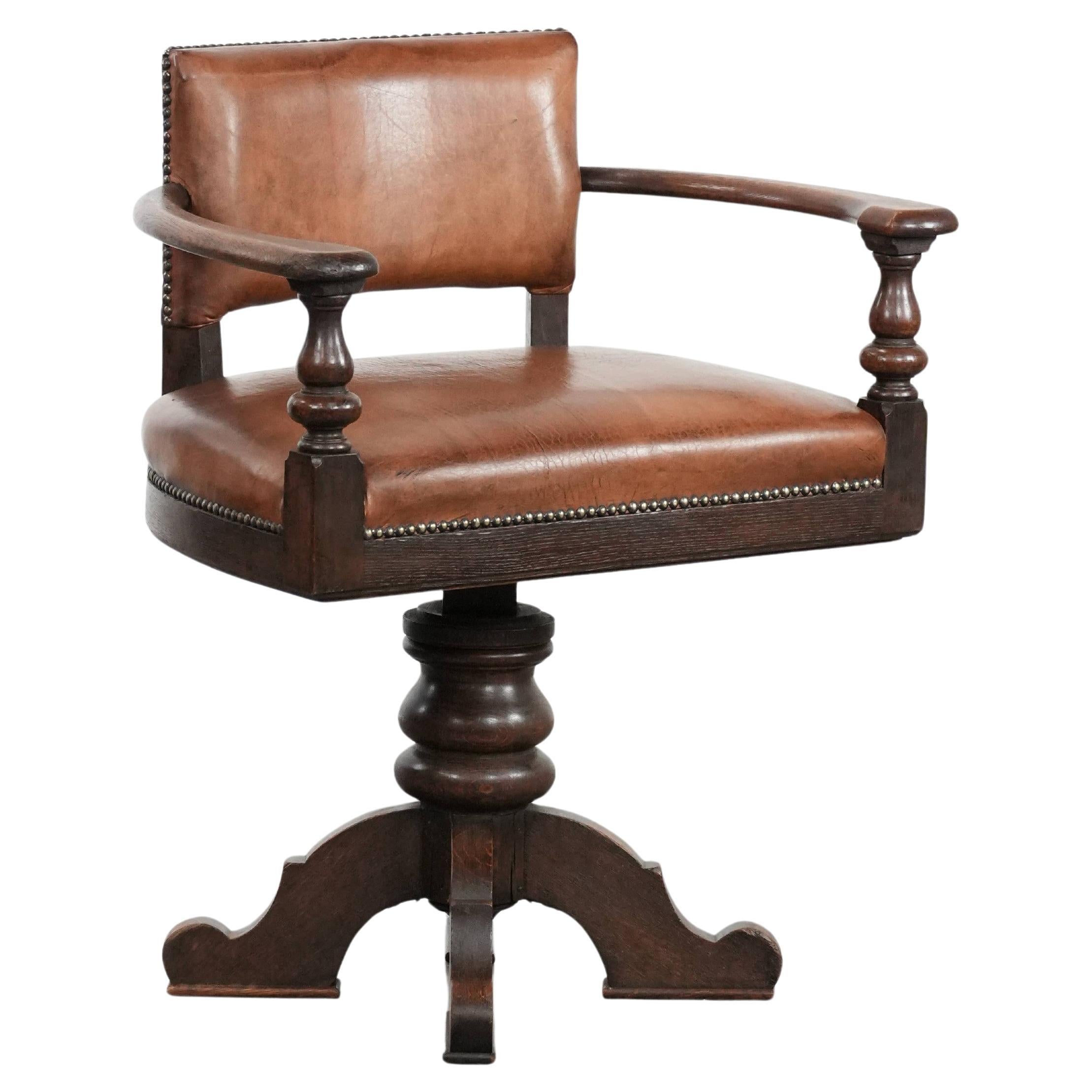Elegant antique sheepskin leather desk chair with a heavy wooden frame For Sale