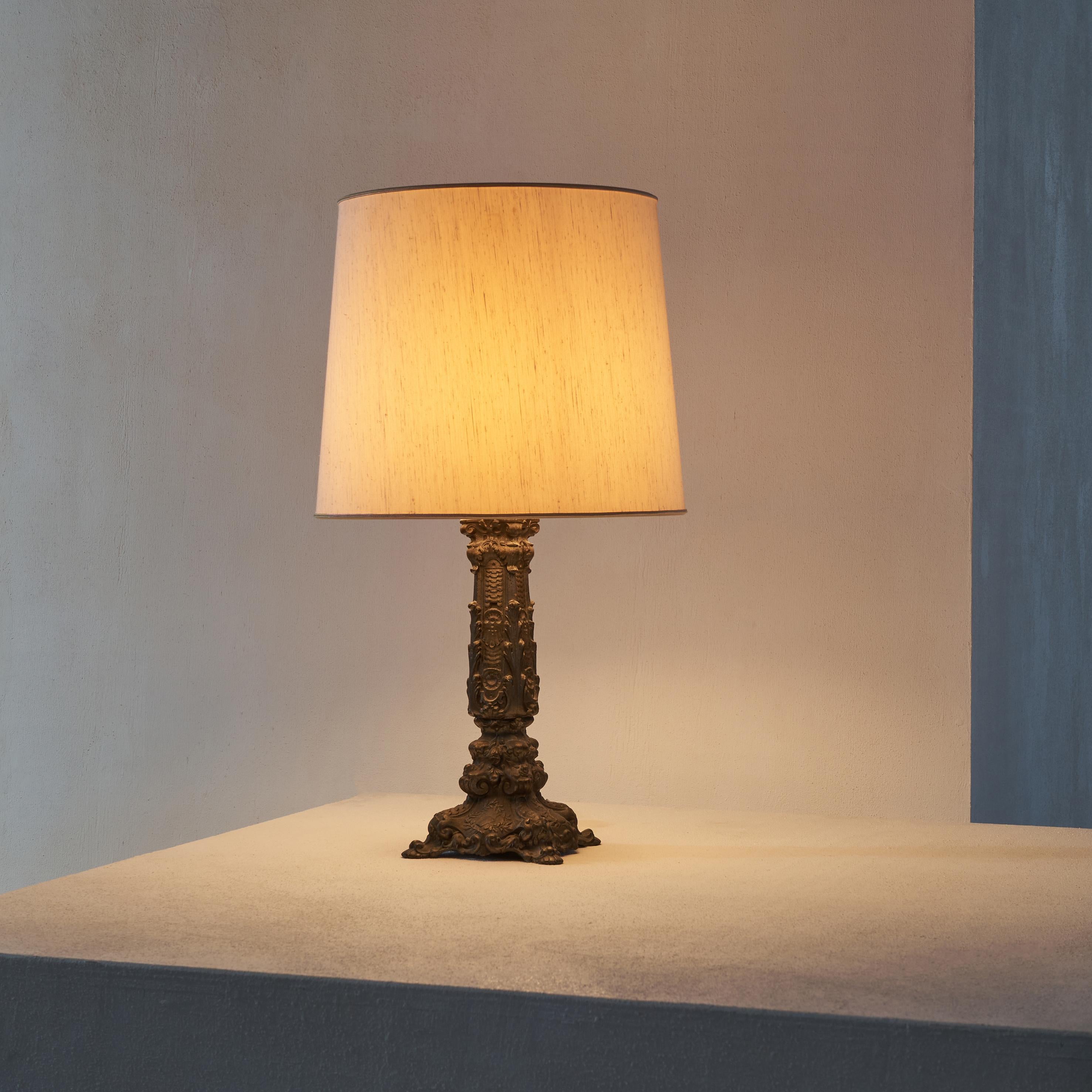 Elegant antique table lamp, late 19th century / early 20th century. 

Very decorative and elegant antique table lamp. Rich and classic in design, looking a bit baroque or rococo but subtle and symmetrical when seen up close. Overall it is a very