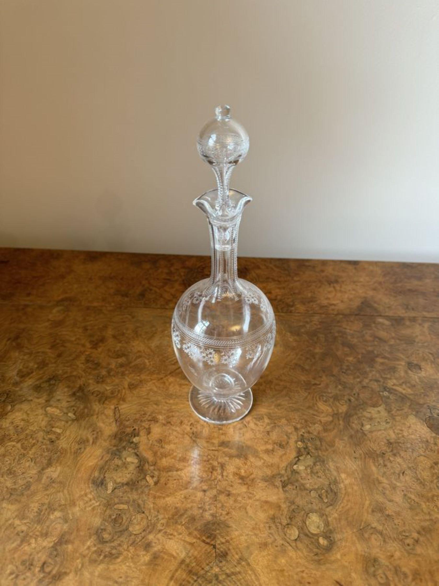 Elegant antique Victorian decanter having an elegant antique Victorian decanter decorated with flowers, with a wavy shaped top, the original stopper raised on a circular shaped base.

D. 1880