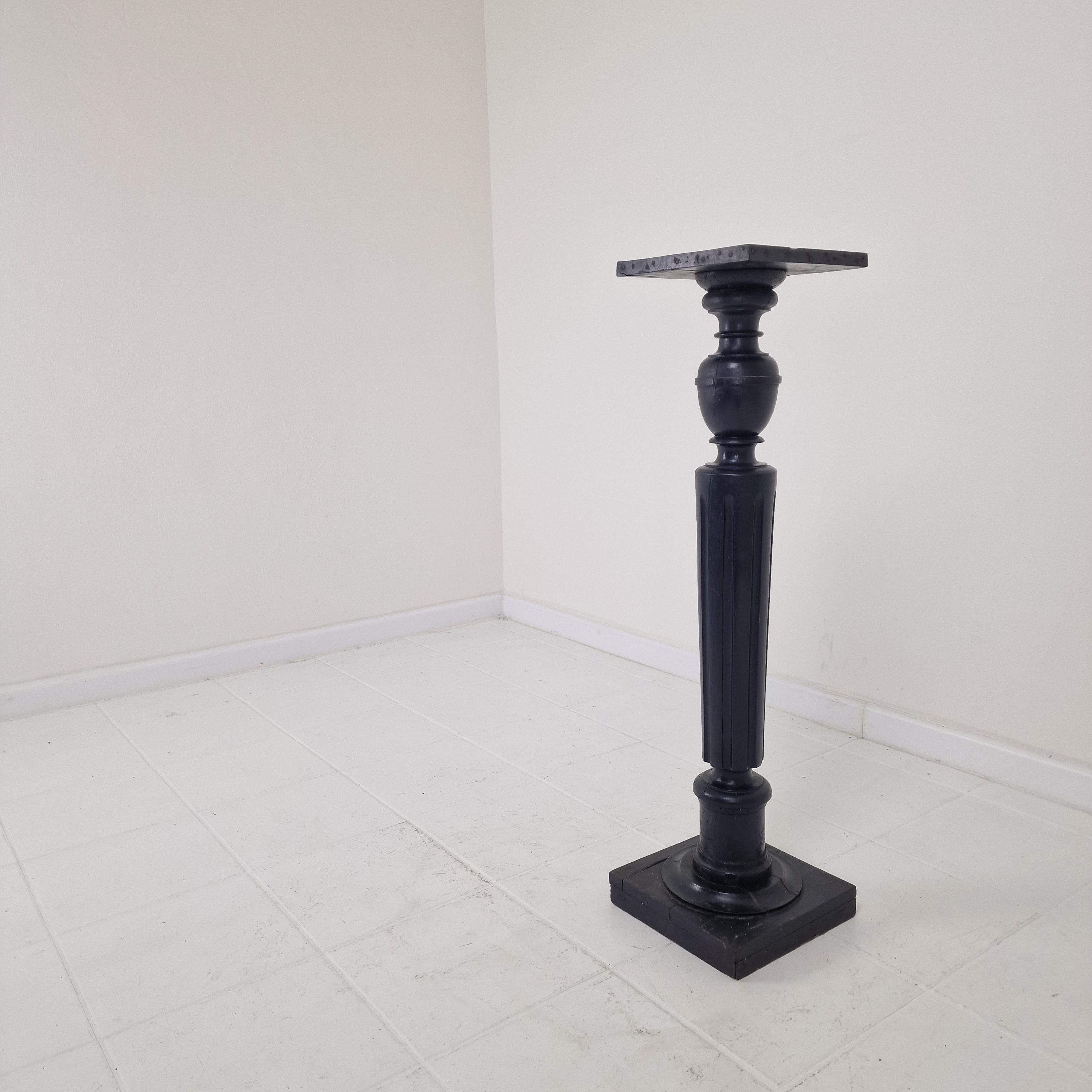 This 19th-century wooden pedestal, handcrafted in France, offers an abundance of historic charm and rustic elegance. 
With its deeply weathered surface, worn edges, and visible signs of age, this piece tells a story all its own — a true testament to