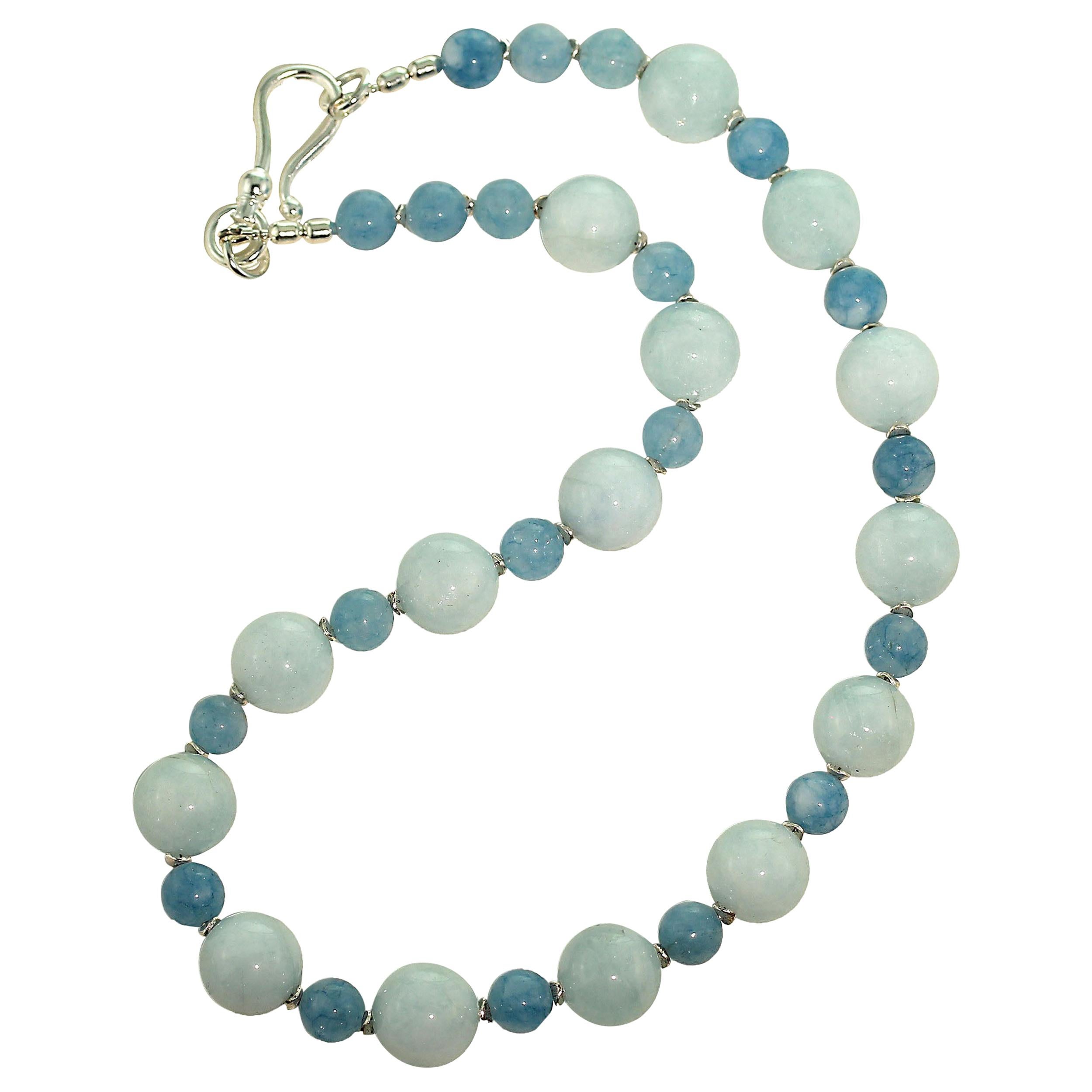 Unique, handmade necklace of genuine Aquamarine in two sizes and shapes. These gorgeous, highly polished Aquamarine are 15 MM and 10 MM and accented with silver tone flutters. Don't miss this elegant color combination of one of our favorite