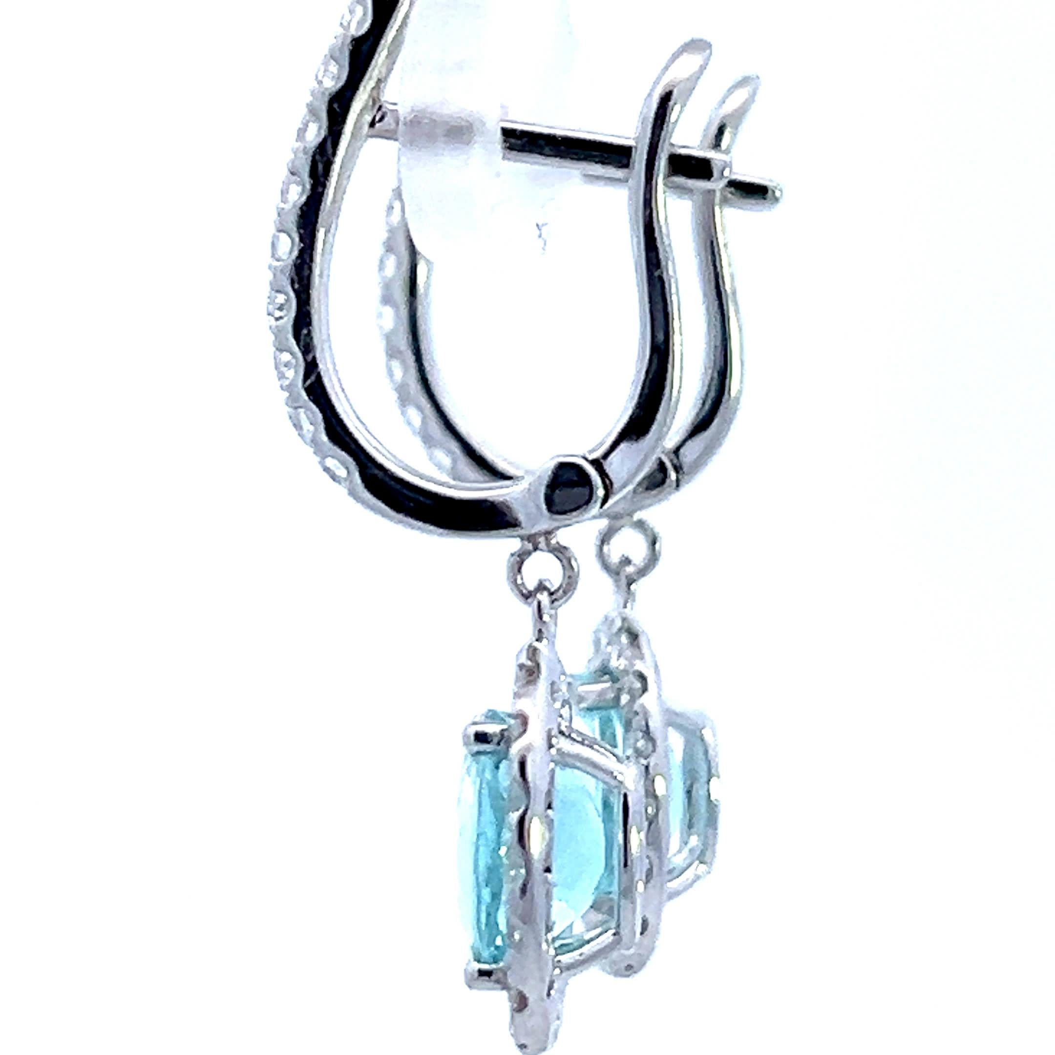 Questi squisiti orecchini a goccia con acquamarina sono un'aggiunta straordinaria a qualsiasi collezione di gioielli. Caratterizzati da scintillanti gemme di acquamarina circondate da un'aureola di diamanti scintillanti, offrono un mix perfetto di