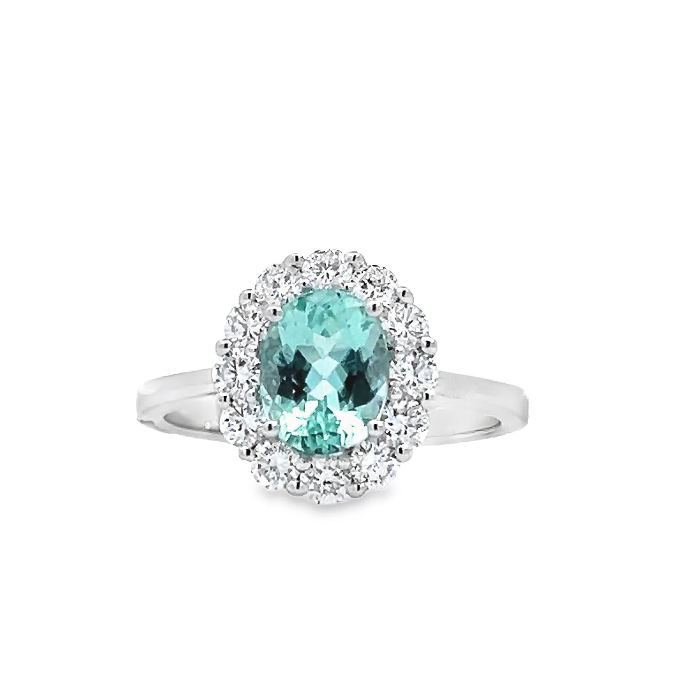 Scopri la squisita bellezza di questo anello con aureola di acquamarina, progettato per affascinare e incantare. La splendida pietra centrale di acquamarina è circondata da un'aureola scintillante di diamanti, creando un mix perfetto di eleganza e