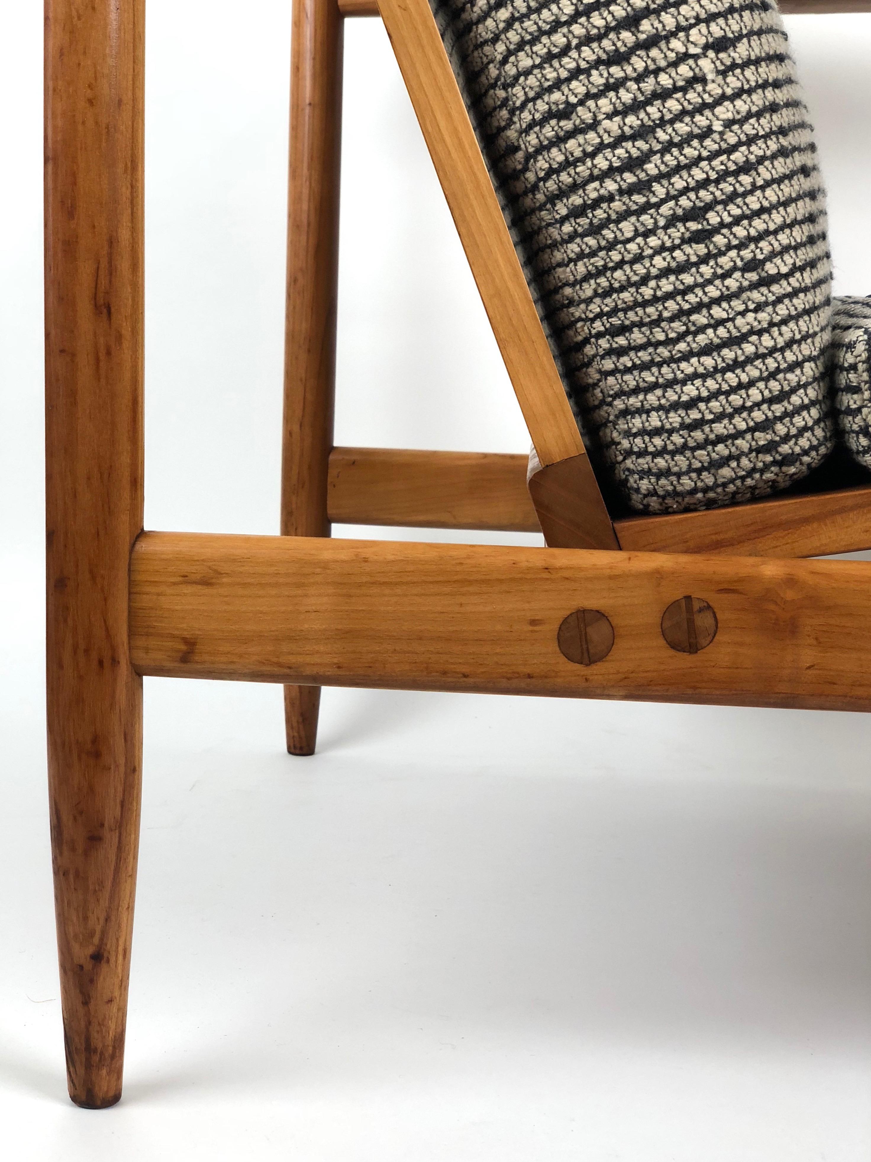 A beautiful arm chair from Uluv in cherrywood. Handmade by one individual from start to finish. The upholstery is original with padding made from sea grass. Sea grass was used by many manufacturers in Europe. Today it represents a biological