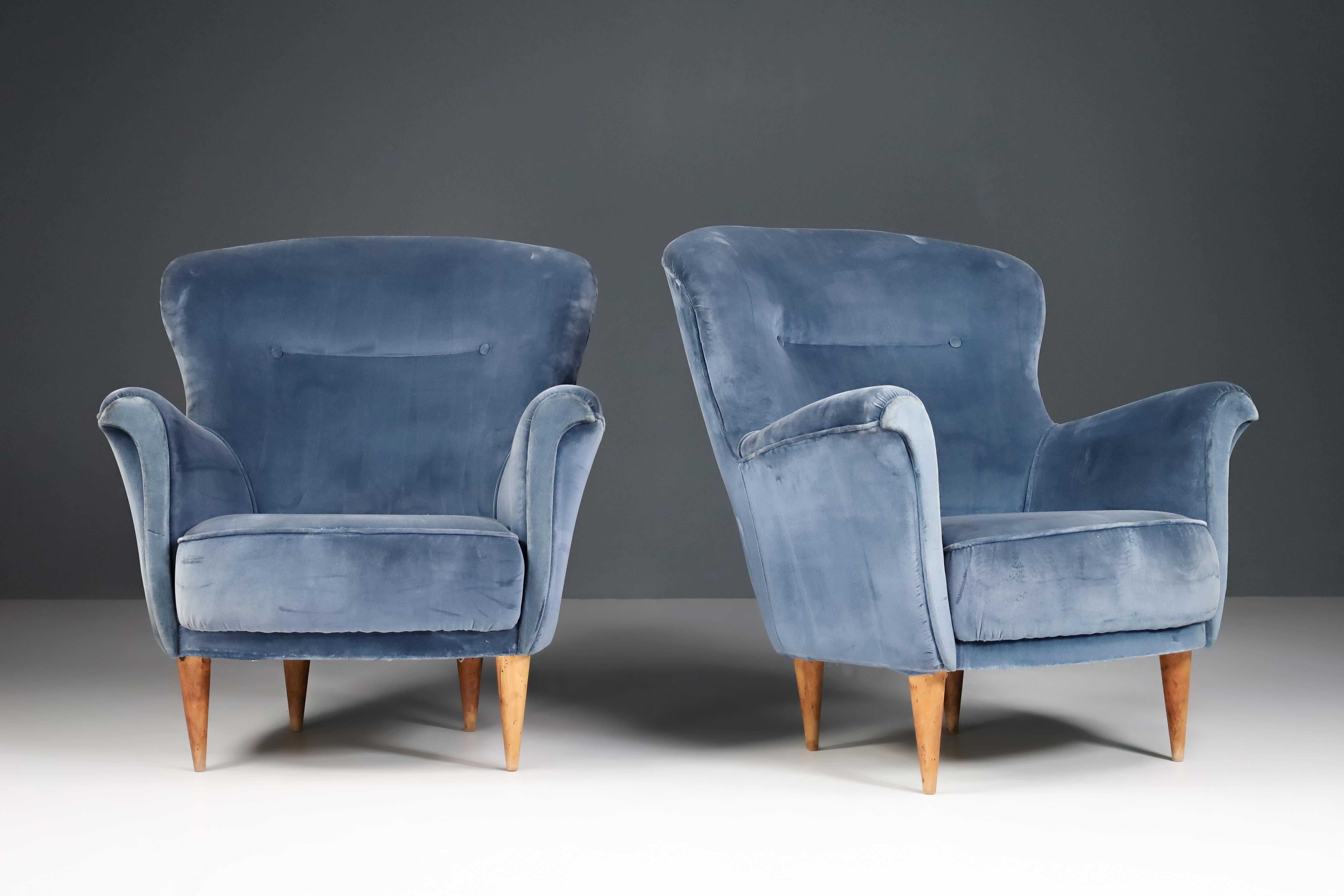 Armchairs with Tapered Wooden Legs attributed Cesare Lacca, Italy, the 1950s.

Pairing two luxury armchairs with tapered wooden legs in original blue upholstery was attributed to Cesare Lacca, Italy, in the 1950s and designed by the famous Cesare
