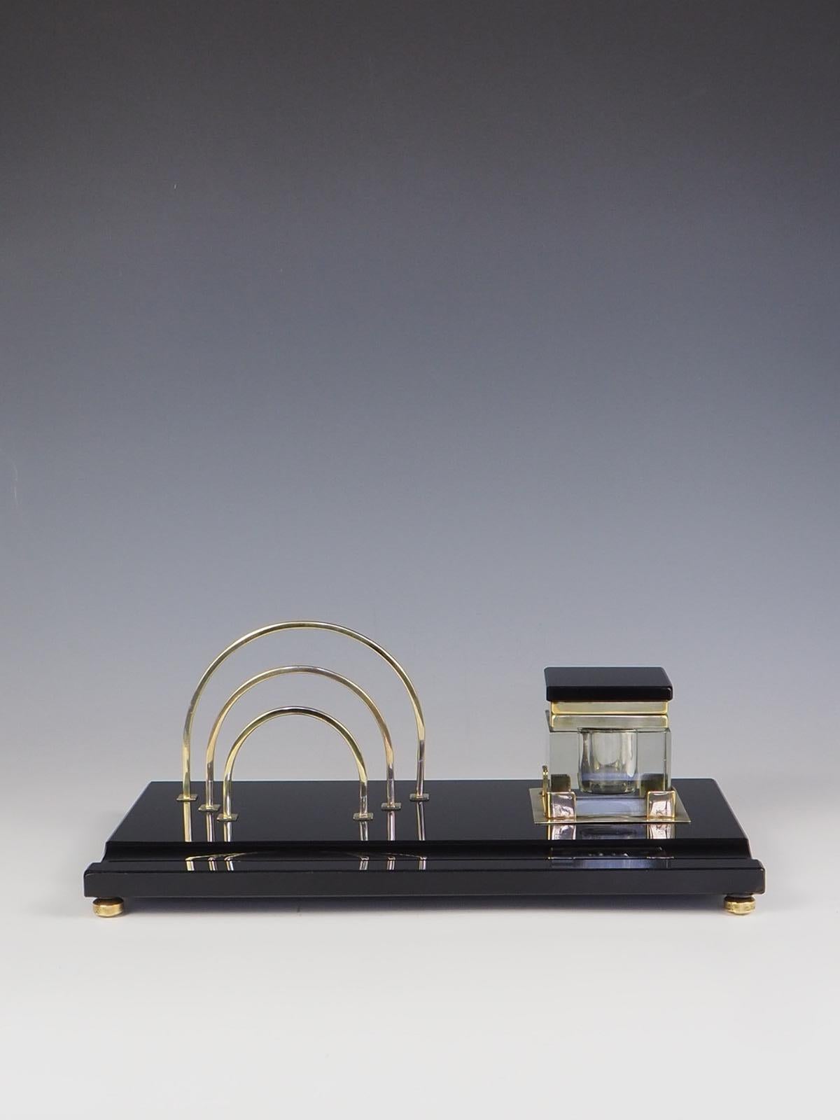 Elegant Art Deco Black & Gold Desk Tidy is a stunning piece that exudes sophistication and style. Crafted from black glass, this desk tidy features intricate gold detailing that adds a touch of luxury.

Desk tidy includes an ink well, letter rack,