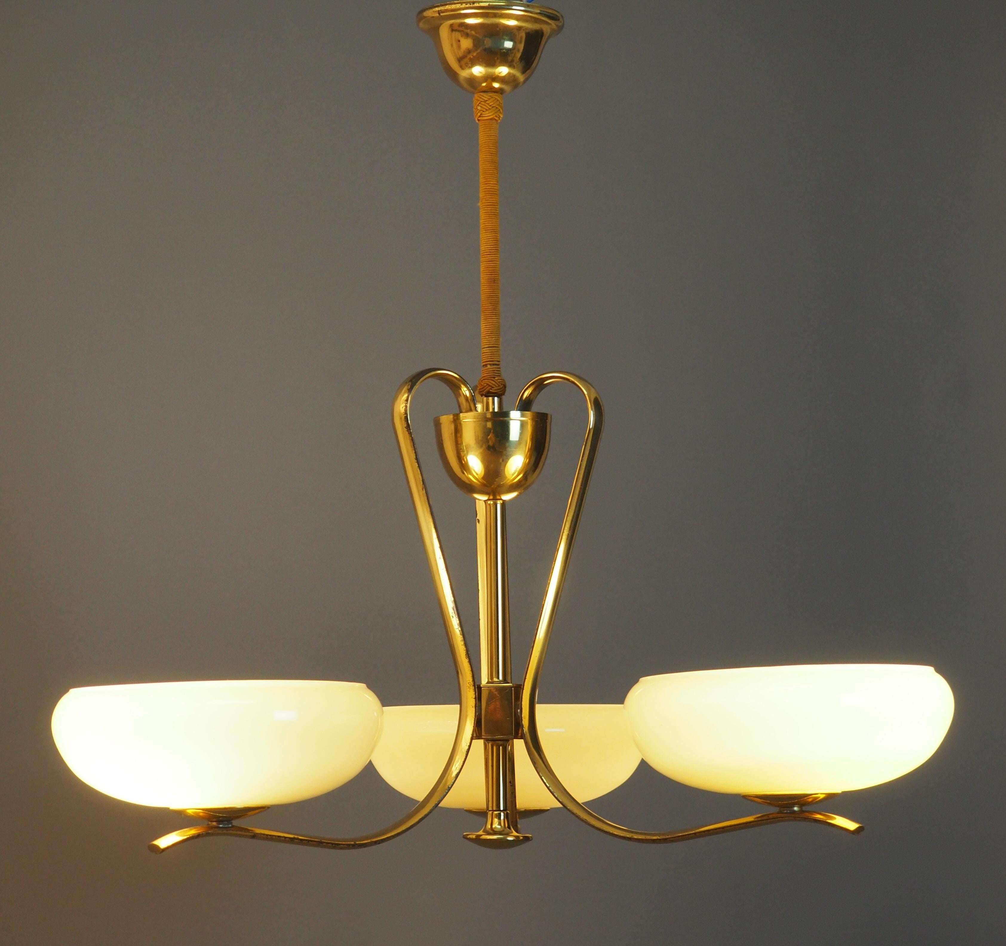 Very elegant Art Deco glass and brass chandelier circa Bauhaus, Germany, circa 1930s.
This beautiful chandelier is made of polished brass frame and opal glass round shades.
Socket: 3 x Edison (e27) for standard screw bulbs.

  