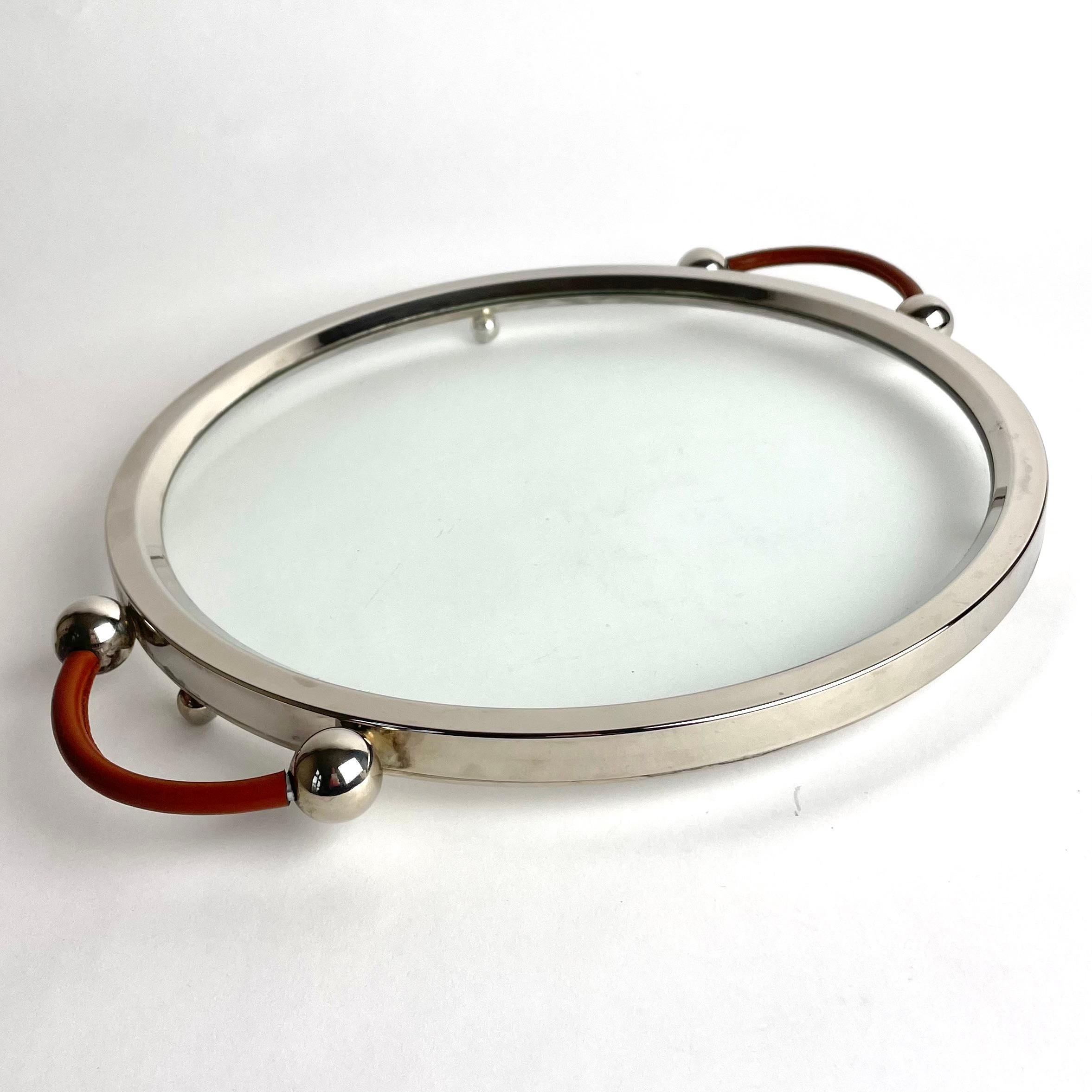 Elegant Art Deco Cocktail Tray from the 1920s in glass, silver plate and leather. Made in glass with a silver-plated metal frame and leather-covered handles. Very period Art Deco.

Wear consistent with age and use