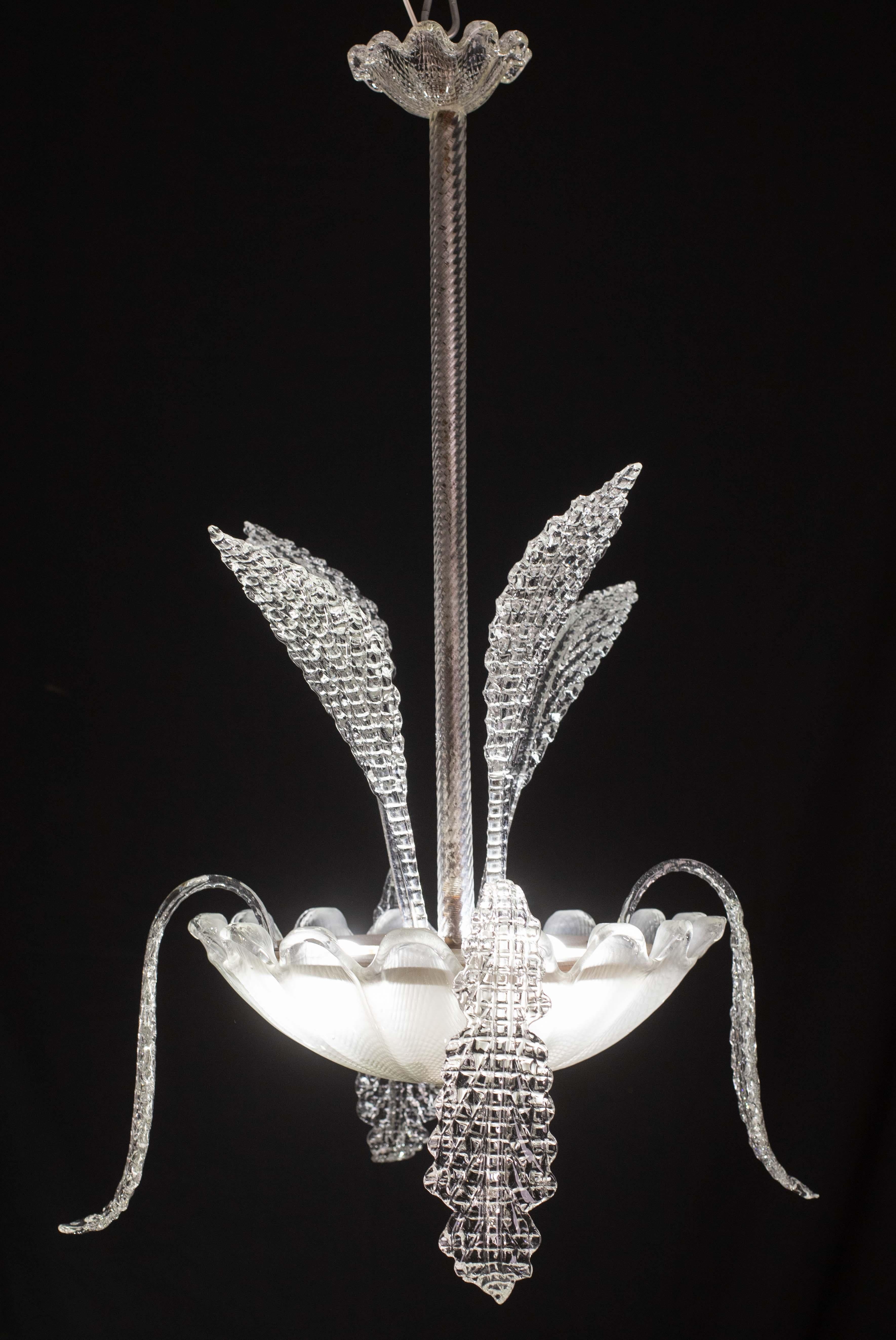 Extraordinary Art Deco chandelier attribuited to the glassworks Barovier & Toso in the 1940s-1950s.
The chandelier is 90 centimetres high and 60 centimetres wide.
It mounts three E27 lights, possible to switch for Usa standards. The chandelier is