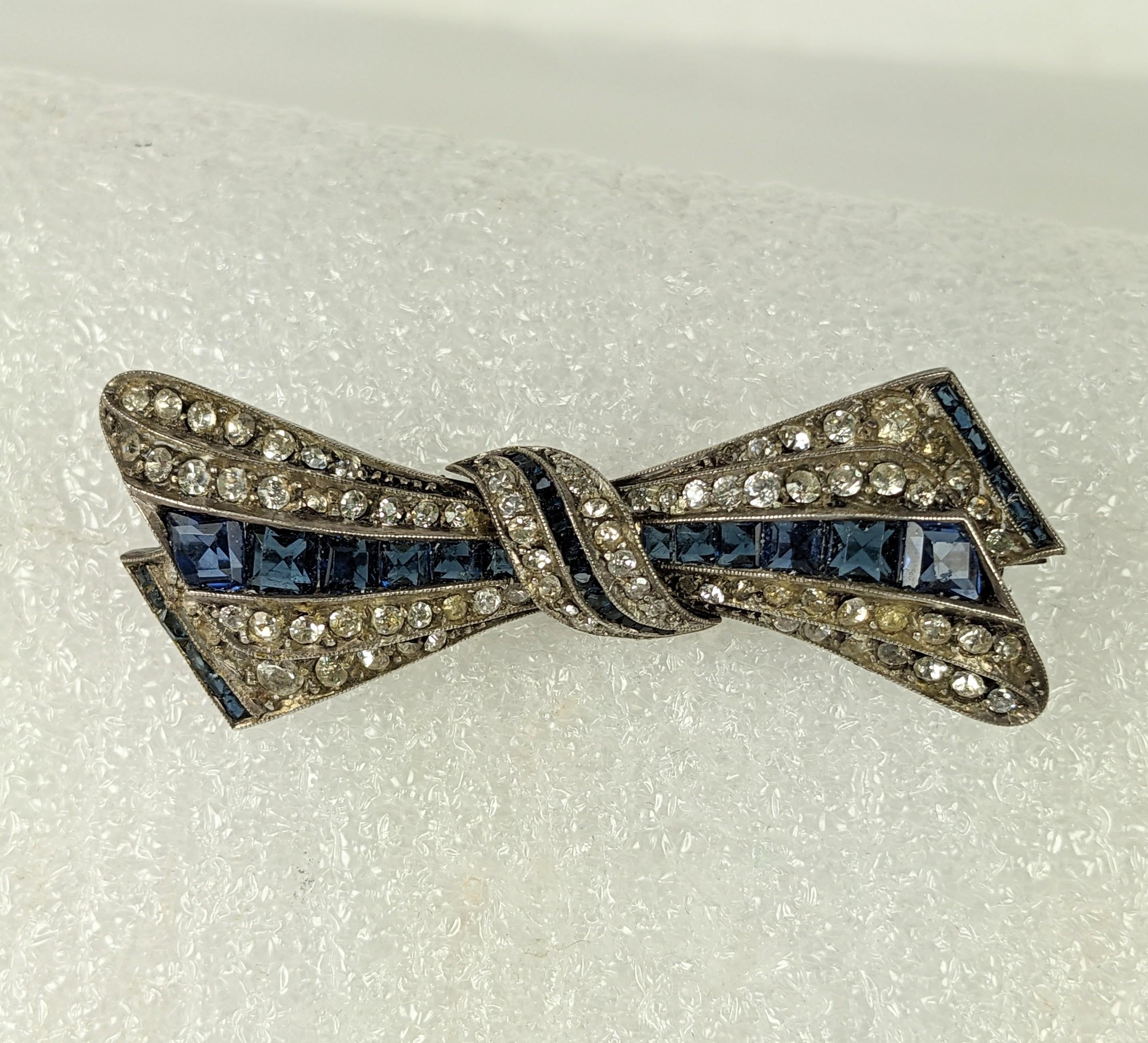High quality Art Deco Paste Sapphire Bow set in sterling silver from the 1920's. Set with tiny calibre sapphire pastes with crystal pave accents. 2