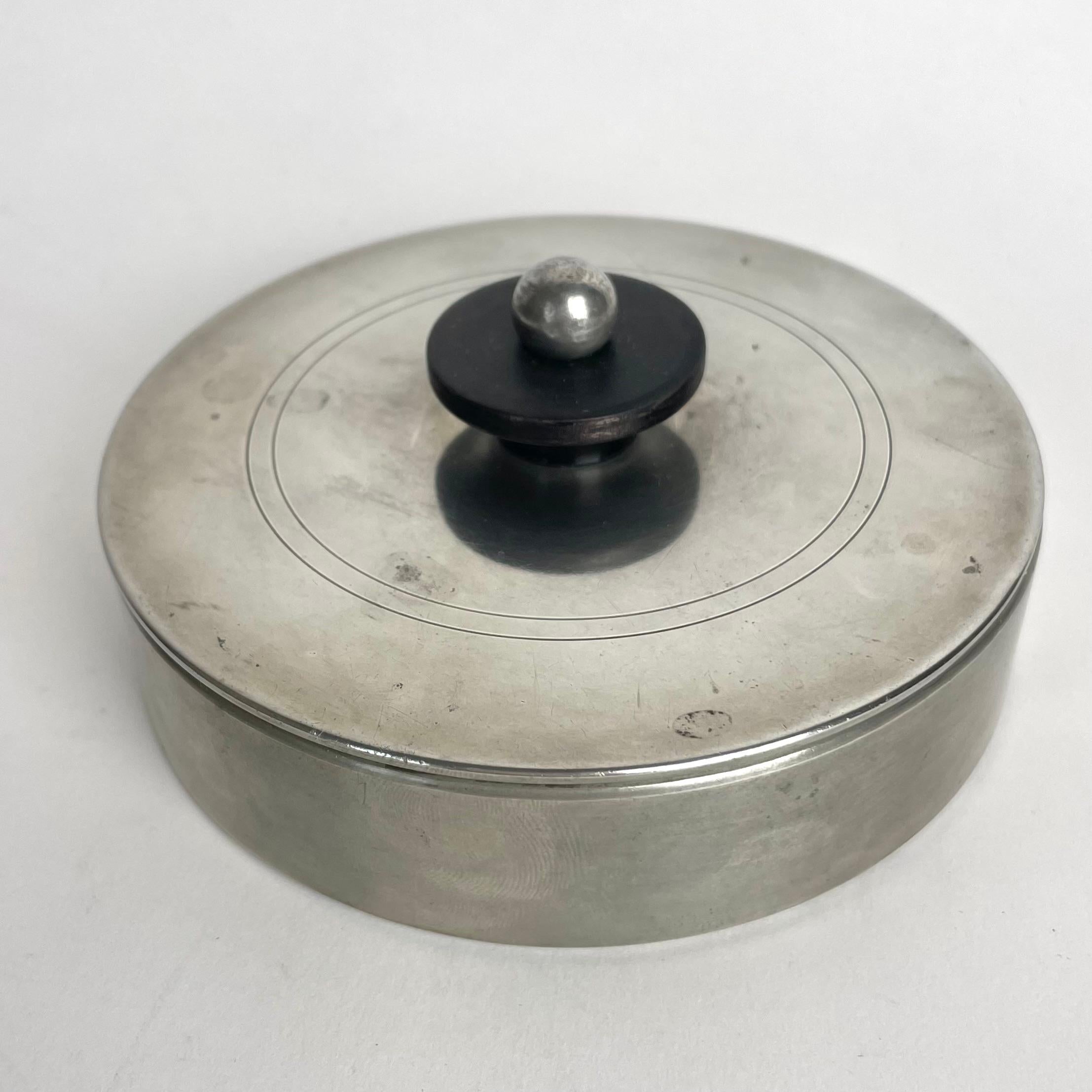 Elegant Art Deco Pewter box with lid and mirror inside from GAB Guldsmedsaktiebolaget, Sweden in 1935 (I8). Simple and elegant design in pewter with blackened birch handle.

Wear consistent with age and use 