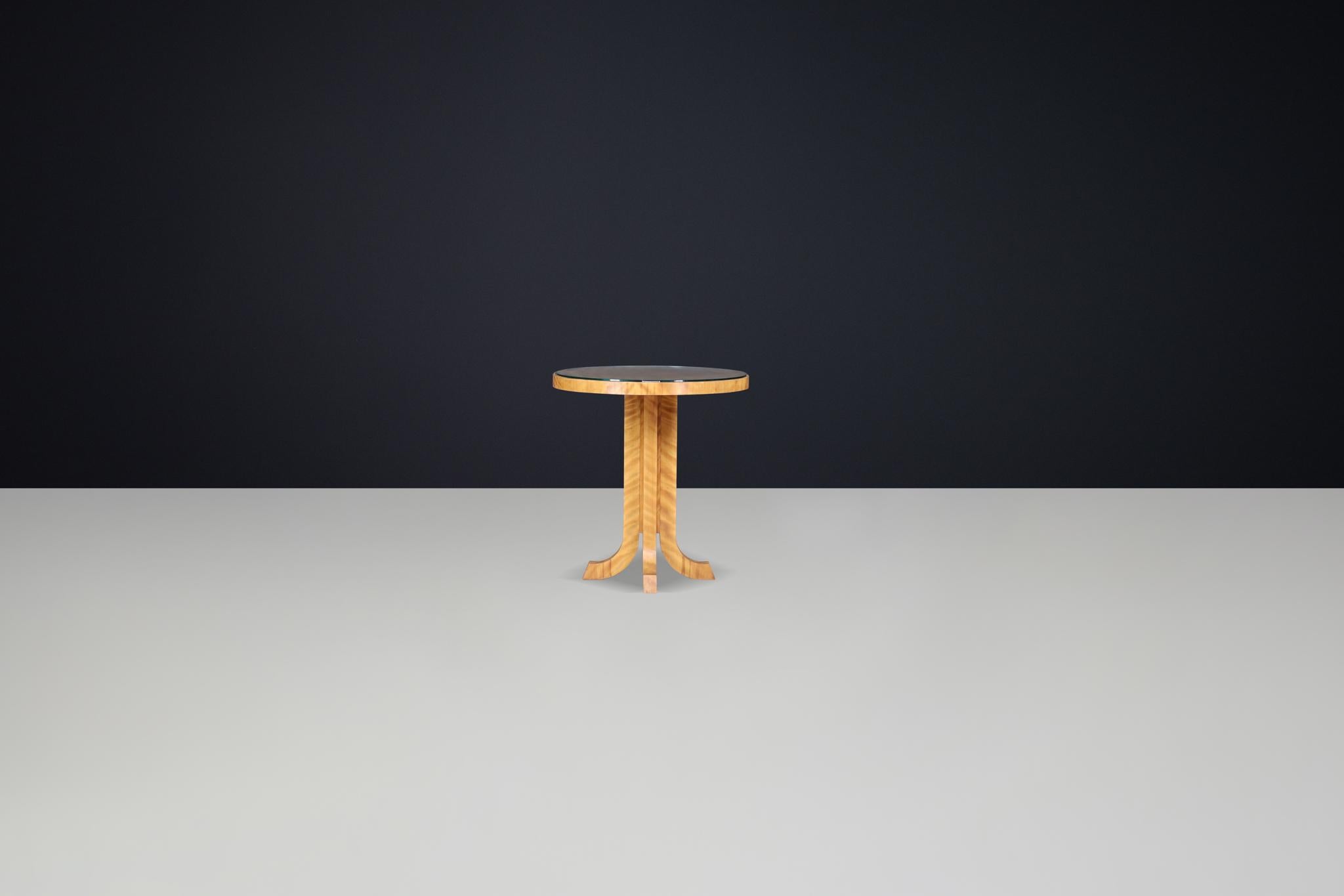 Elegant Art Deco Round Side Table in Birch,  Prague 1930s

This round side table, crafted from birch wood and made in Prague, exemplifies the elegant and geometric forms of the Art Deco style. Its refined finish and warm wood grain enhance the