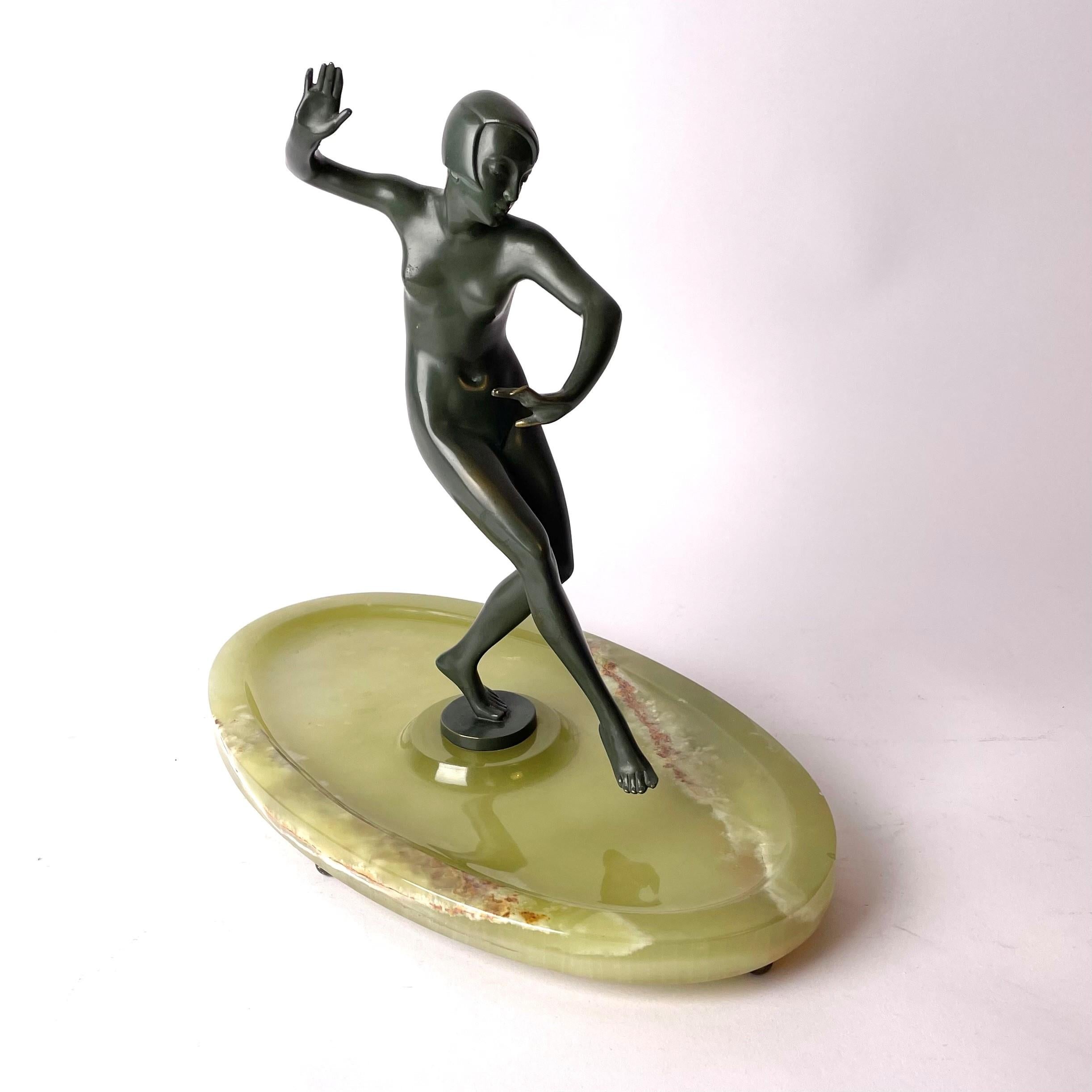 Elegant art deco sculpture by Johann Wolfgang Elischer (Austria 1891-1966). Made in colored bronze with an onyx base. Art Deco circa 1920s and signed in the bronze base.

Wear consistent with age an use.