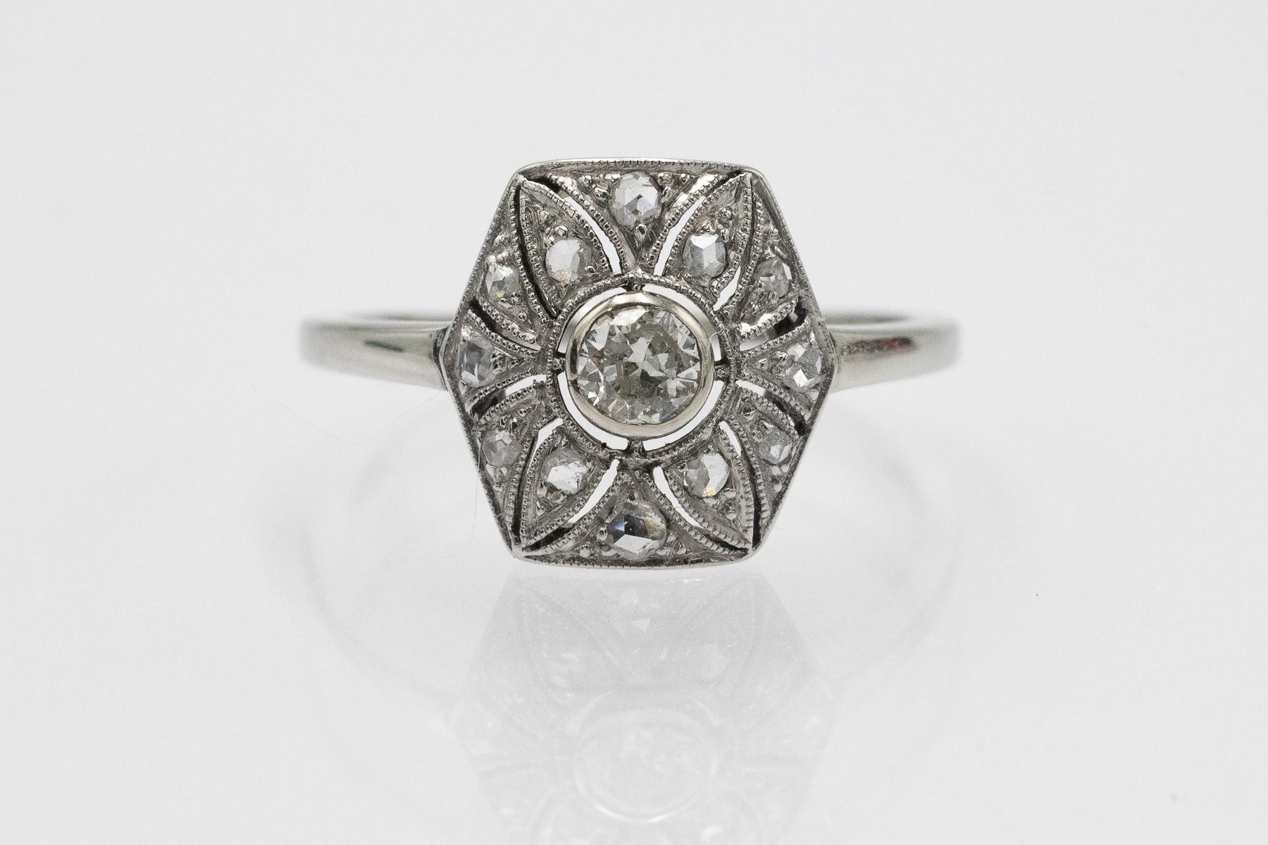 Anello vintage in stile Art Déco geometrico, realizzato in oro bianco 14 carati.

Origine: Austria-Ungheria, un segno distintivo della città di Pest, anni '20.

L'anello è incastonato al centro con un diamante vecchio taglio brillante da 0,15 carati