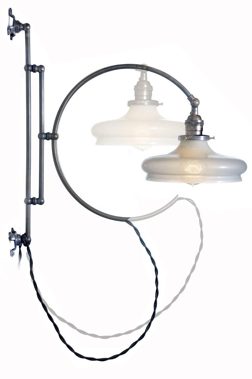 The lines and details of this lamp are just right. The hoop can be turned along its axis and the look changes dramatically. It also swings side to side and moves up and down. The delicate handblown Vaseline glass shade has very elegant lines and