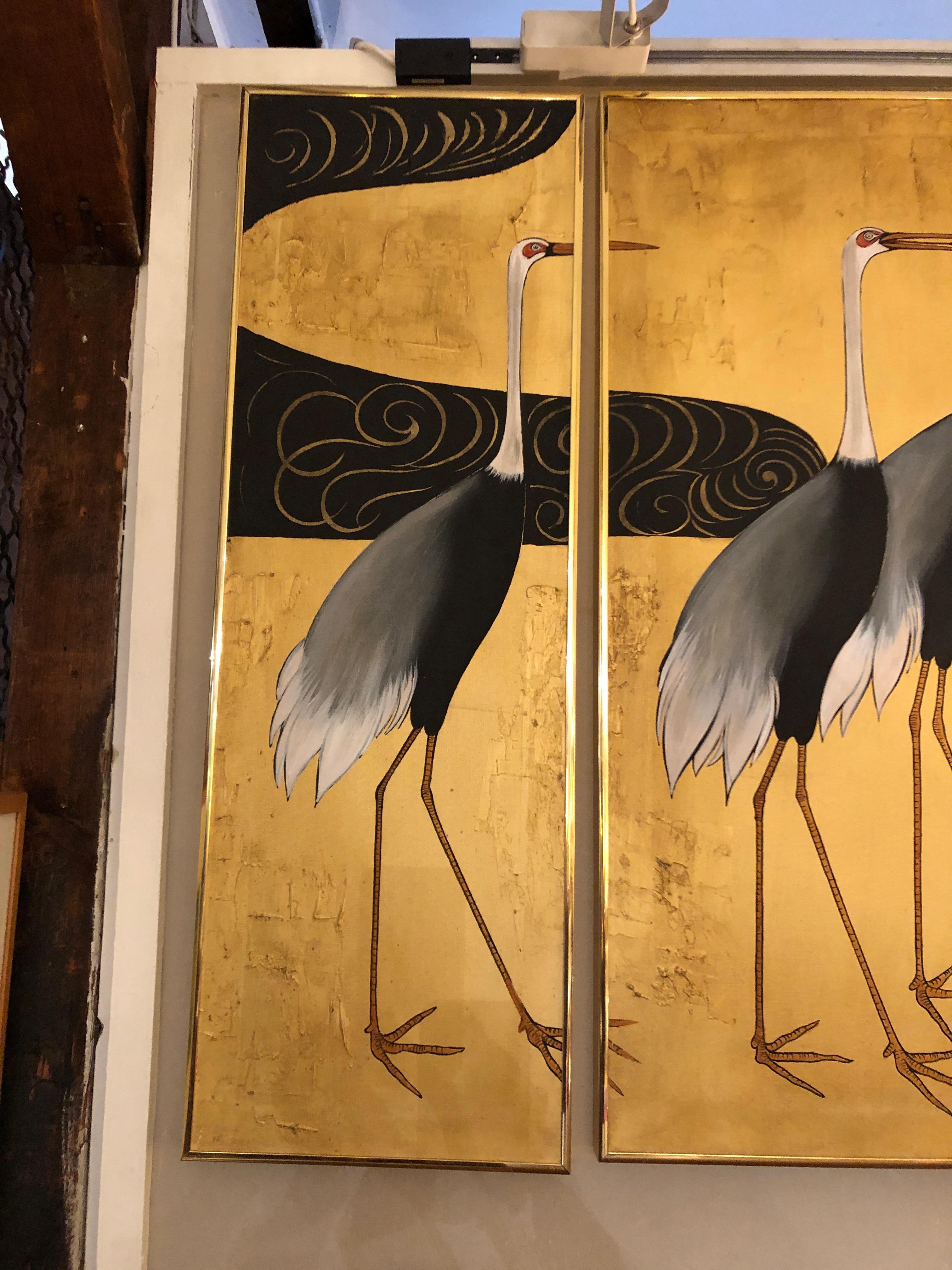 Very beautiful Asian painting of a flock of herons, black and white against a gilded background with Asian lettering lower right and an abstract shape, perhaps water, at upper left. The art is created on 3 canvases that create an elegant triptych,
