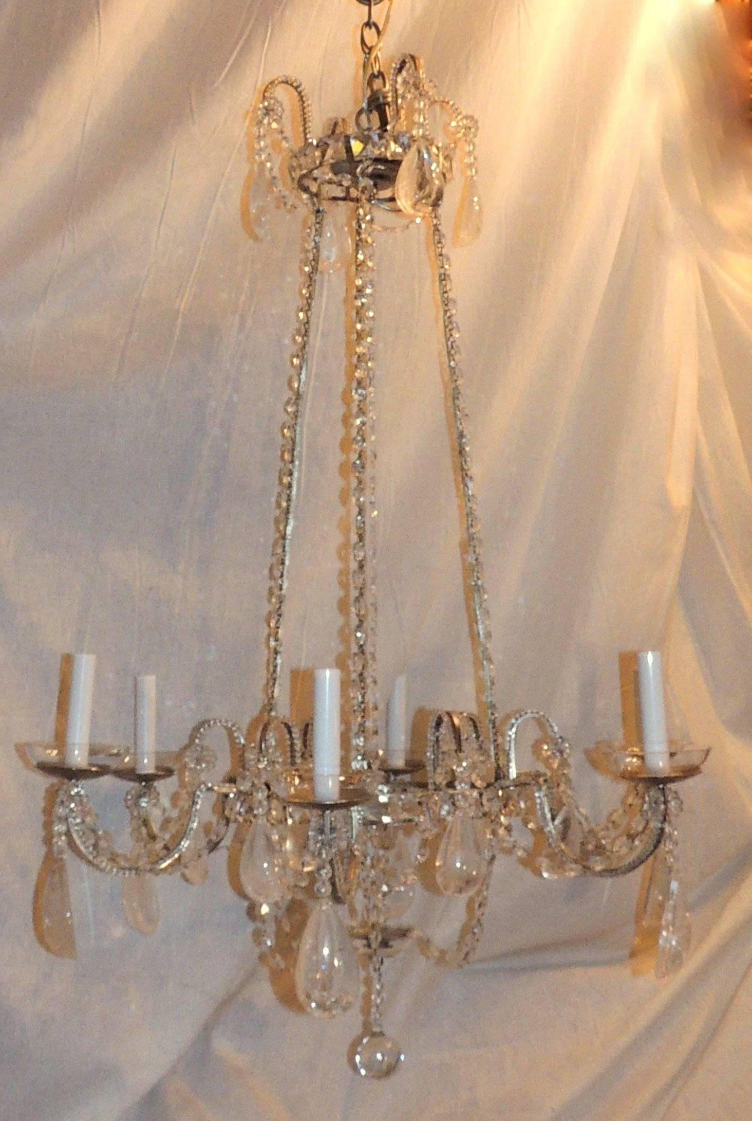 The crystal beads trim the silver body and arms of this rock crystal six-arm chandelier. The crystal chain suspends the lower portion and glass crystal candle cup add to a light open look to this transitional chandelier.

Measures: 38