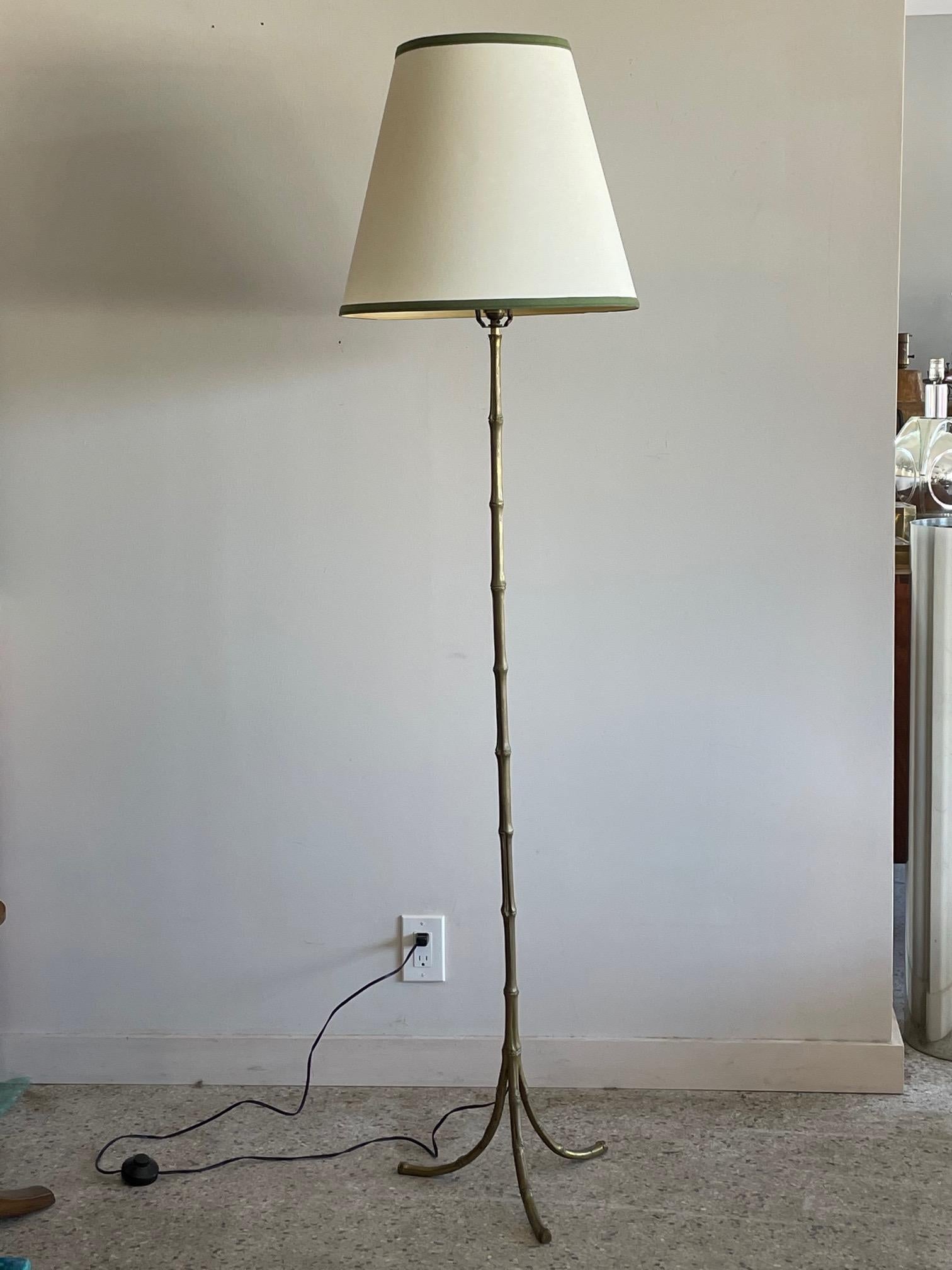 An elegant floor lamp attributed to Bagues. Bronze faux bamboo, beautiful details, heavy and solid, wired with a foot switch.