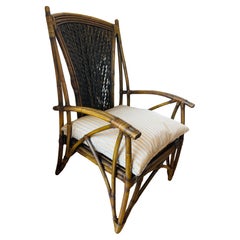 Fauteuil élégant en bambou et rotin avec coussin en plumes de soie