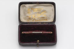 Elegant bar golden brooch with rubies and diamonds, Spain, circa 1940s.