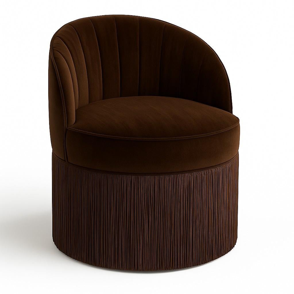 This barrel chair offers a sophisticated blend of form and texture, ideal for discerning design schemes. Its curved silhouette in premium beige velvet features elegant vertical channeling and a distinctive fringe skirt at the base. Available with a