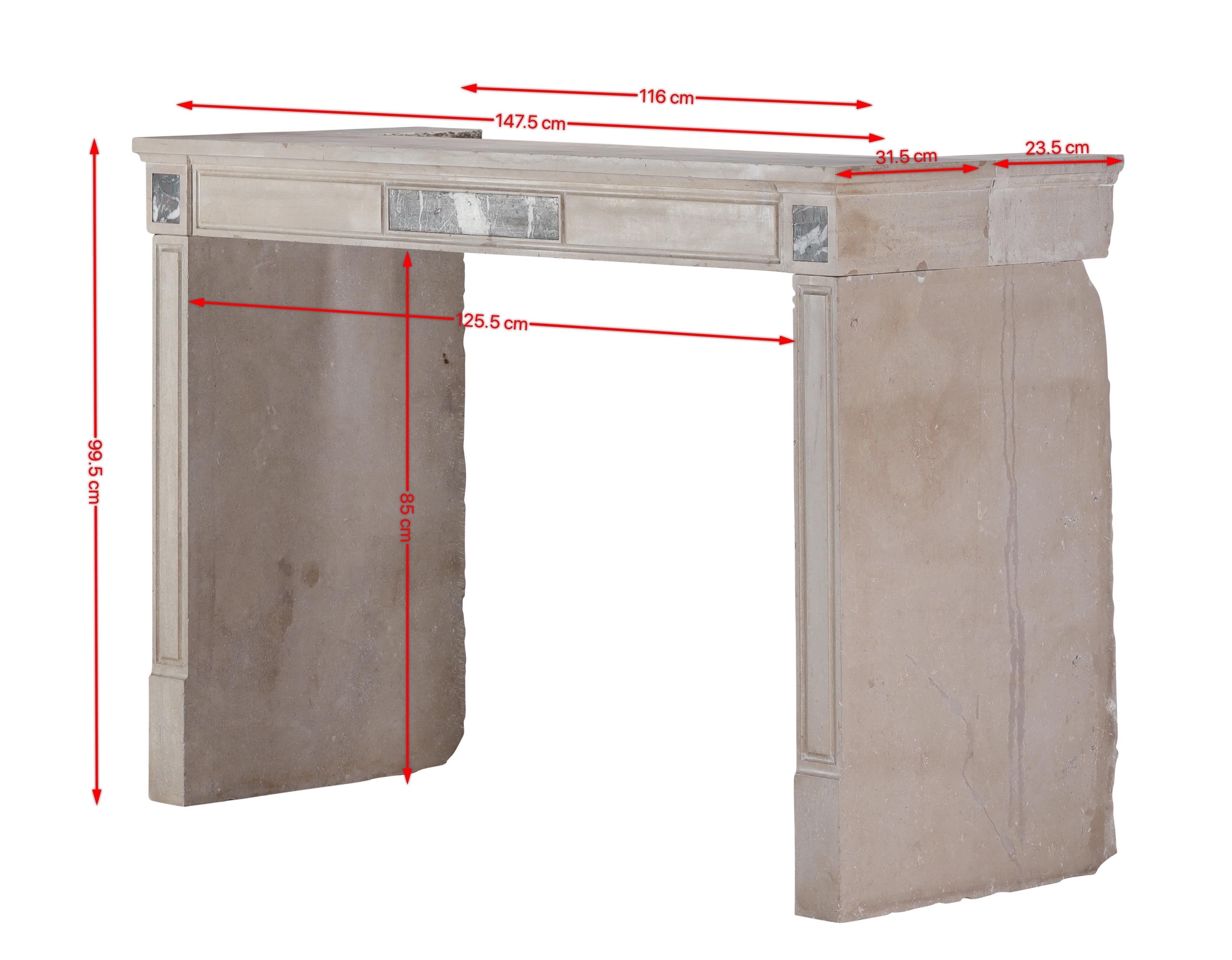 This authentic 19th-century French fireplace mantel is a striking example of refined French architectural design, crafted in hard limestone with elegant Griotte Rubanée marble inlays. The soft eternal beige tones of the stone — enriched with