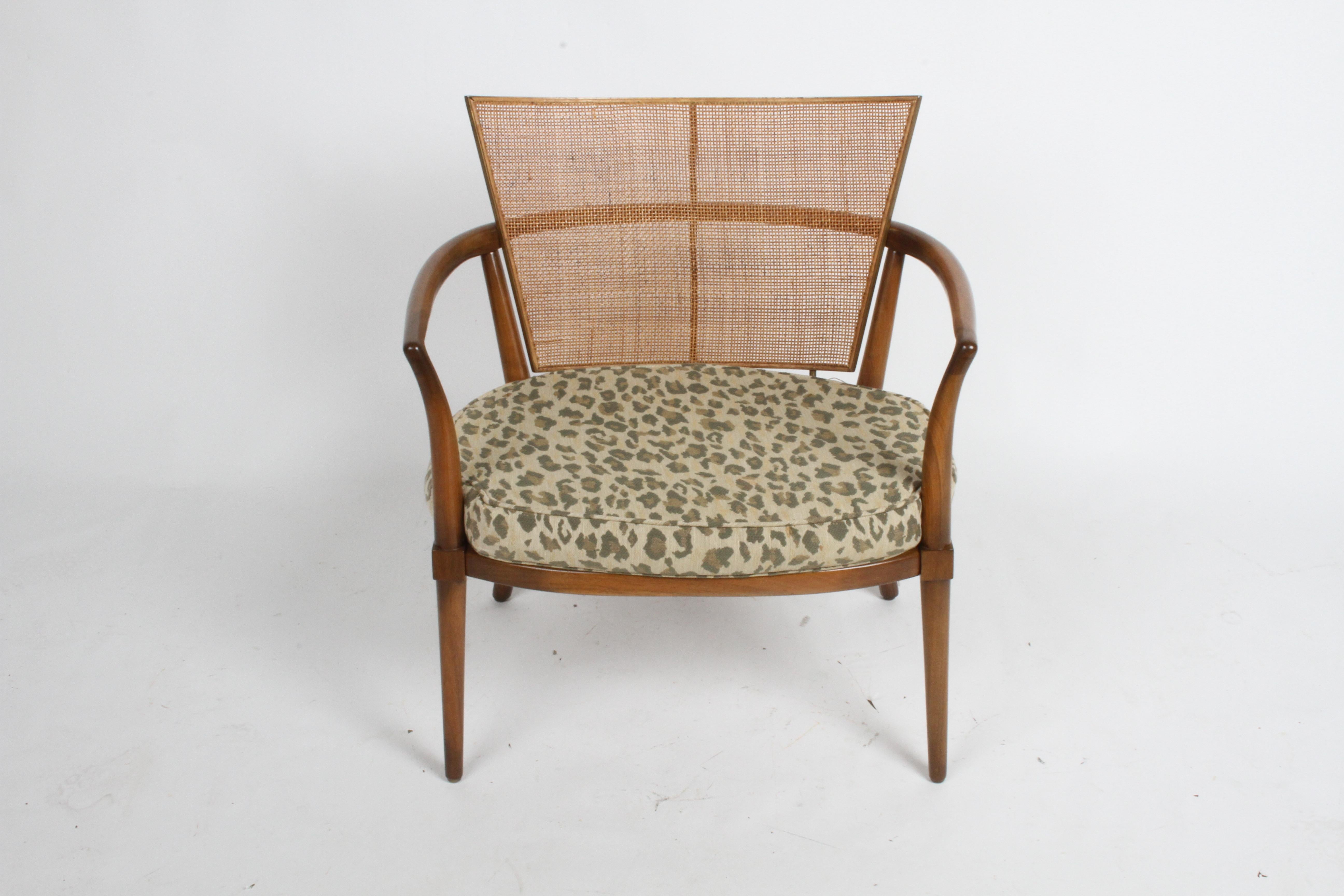 Sculptural lounge chair by Bert England for Johnson Furniture Co. with solid walnut frame, cane back with brass details. Original finish to be touched up, brass has patina, can be polished for additional cost. Loose cushion, older upholstery.