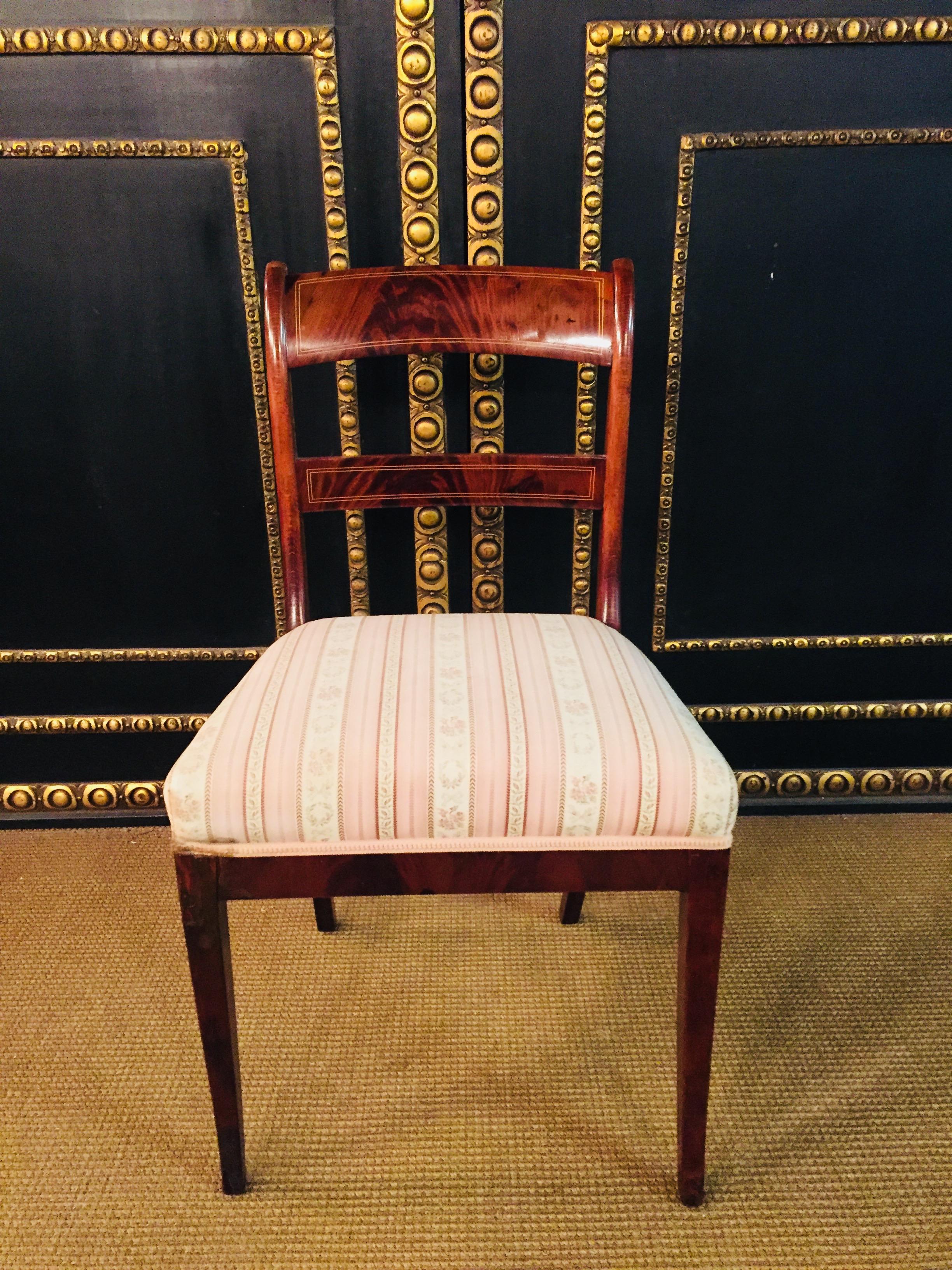 Mahogany. Trapezoidal frame on slightly flared legs. Slightly curved backrest with straight top and middle bridge. High quality thread insert, extremely rare. Excellent warm patina aged over decades. Age-related use traces. A good historical