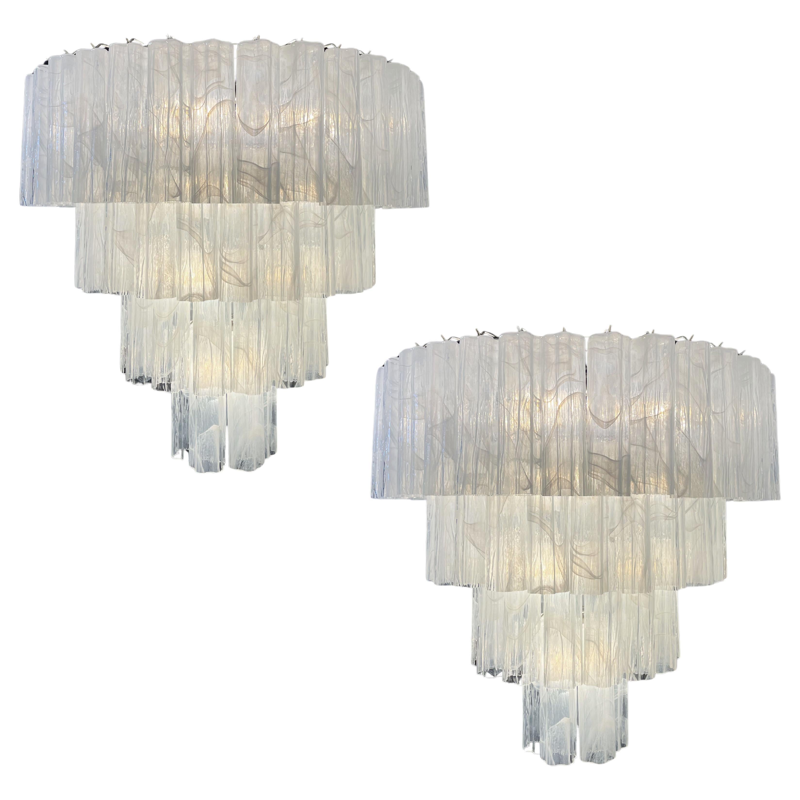 Italian vintage chandeliers in Murano glass and nickel plated metal structures on 4 levels. The armor polished nickel supports 78 large albaster white glass tubes in a star shape.
Period:Late XX century
Dimensions:63 inches (160 cm) height with