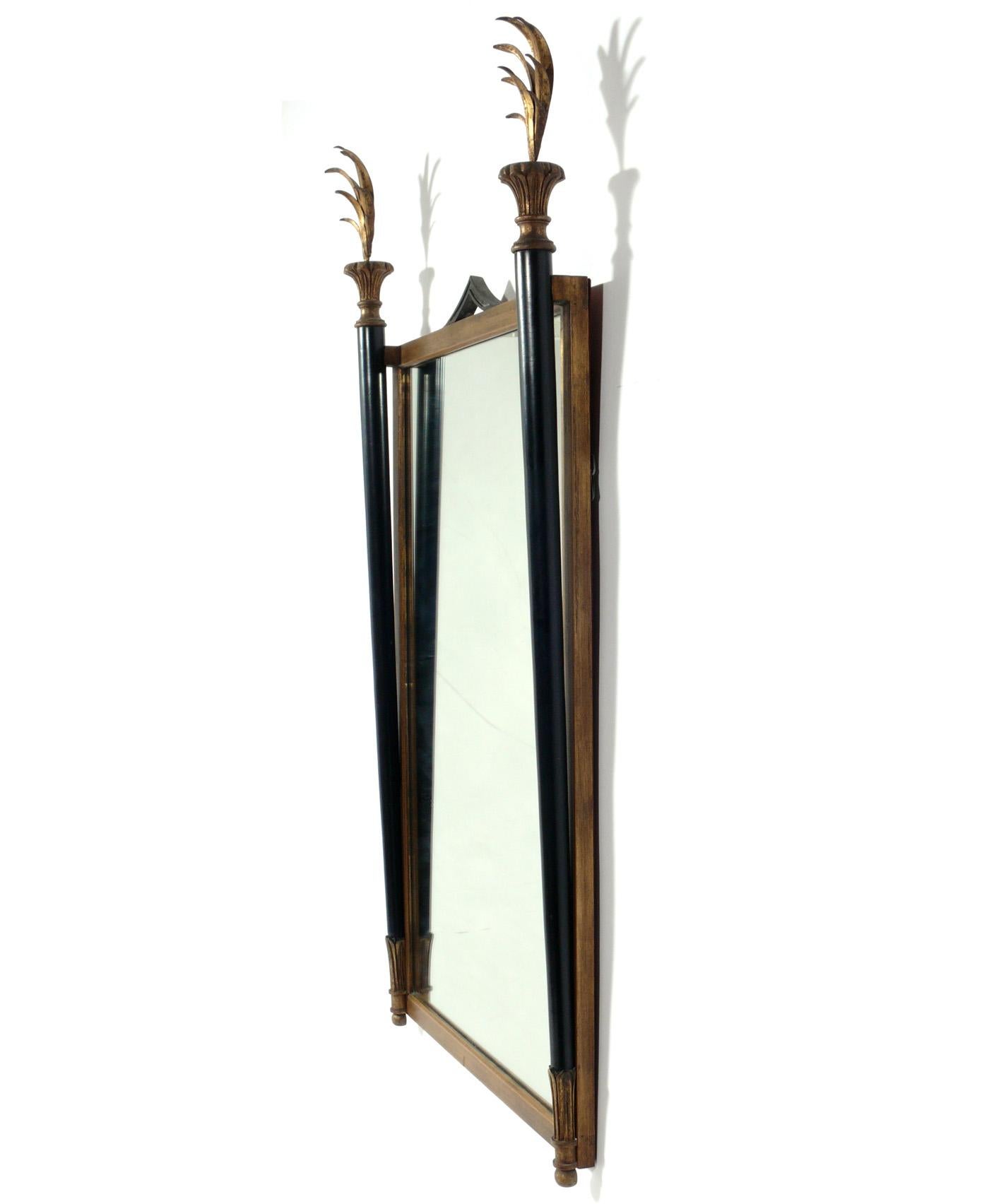 Elegant black and gilt neoclassical mirror by Palladio, Italy, circa 1960s. It measures an impressive 50