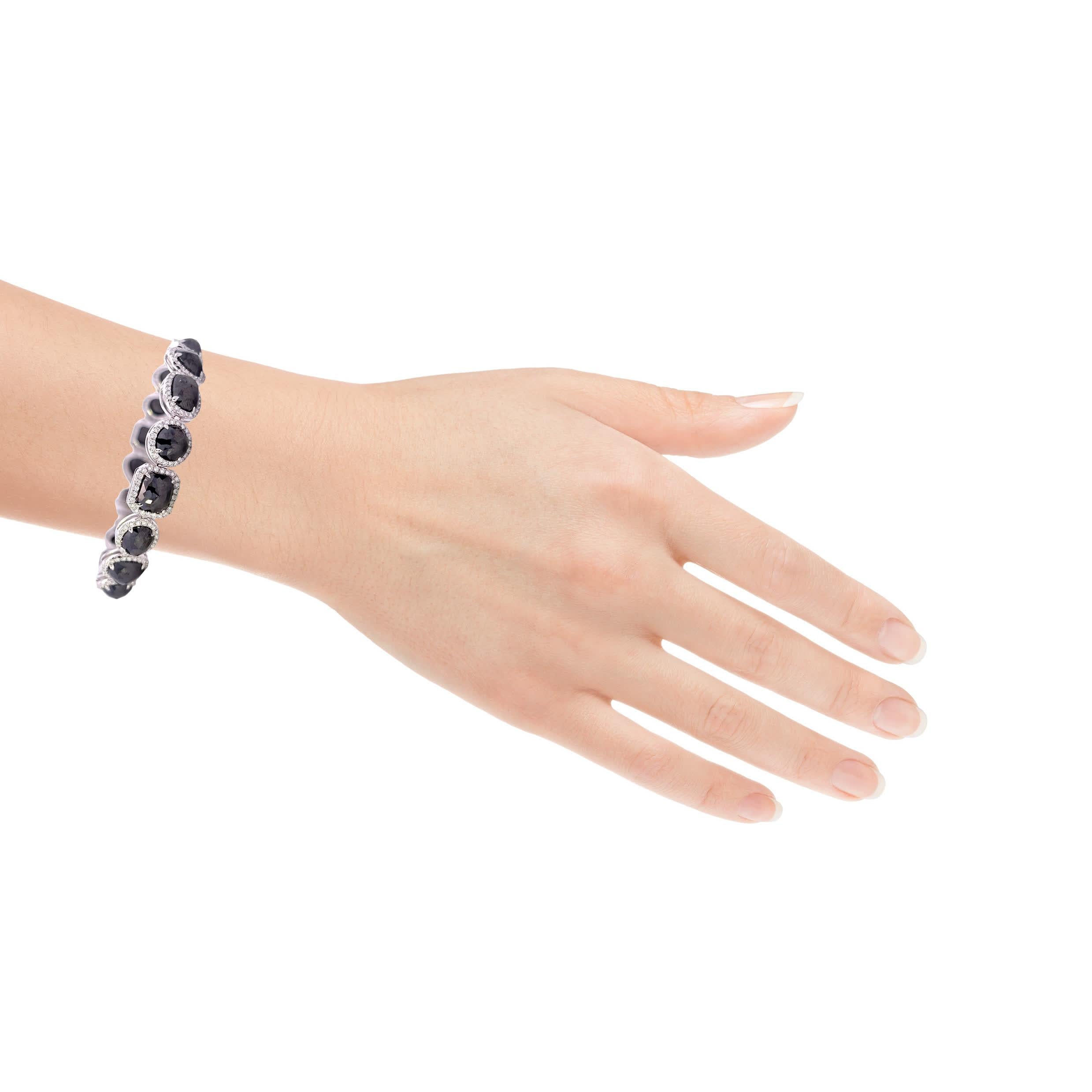 This stunning black gemstone bracelet features a series of intricately designed links, each adorned with sparkling accents. The rich, dark stones are beautifully complemented by the shimmering silver setting, making it a perfect accessory for both