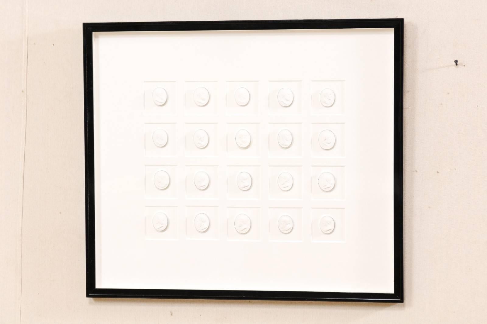 Cast Elegant Black Wall Frame Featuring a Collection of White Intaglios