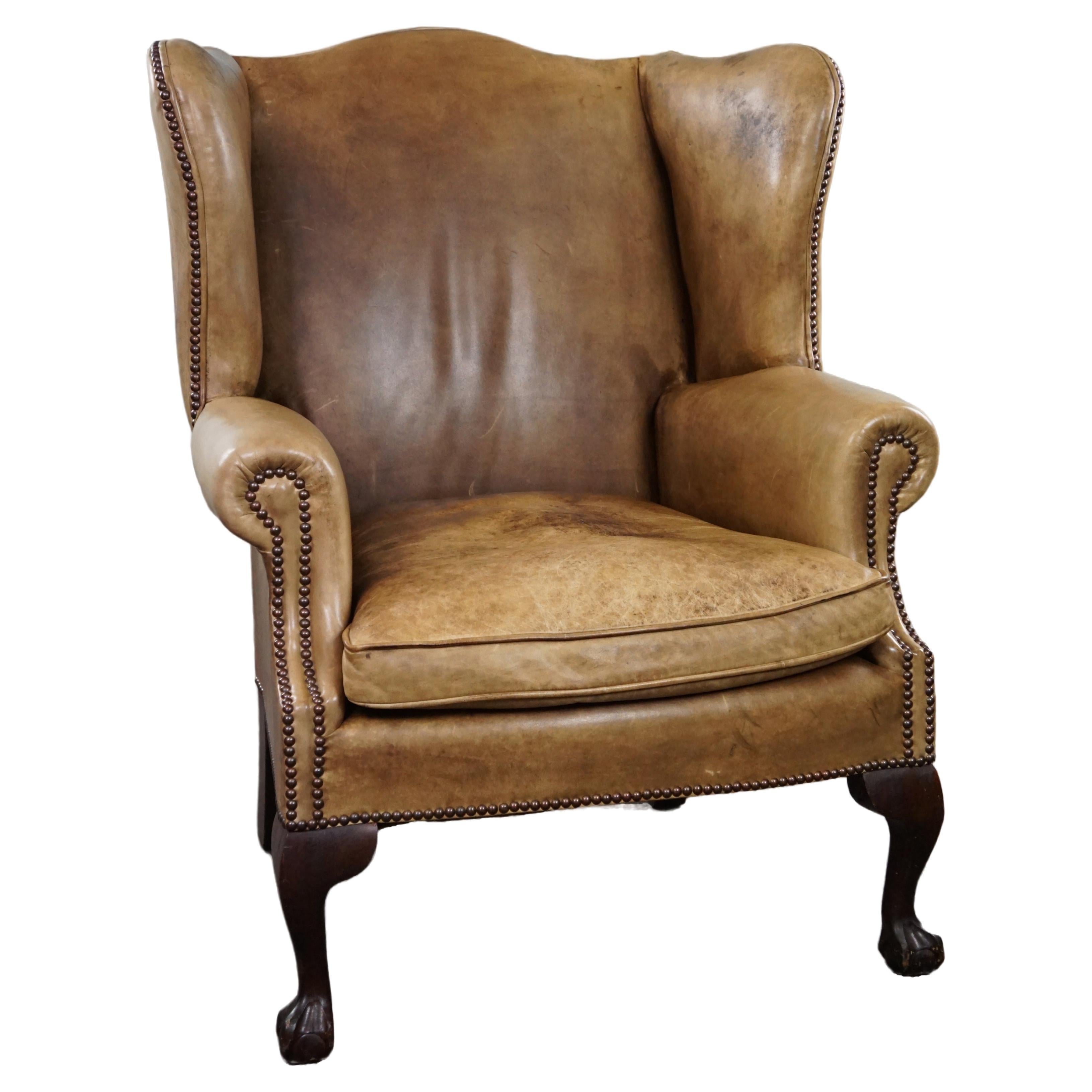 Elegant blonde leather wingback armchair. For Sale at 1stDibs