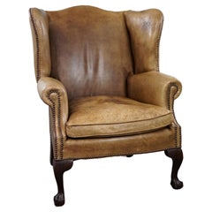 Elegant blonde leather wingback armchair. 