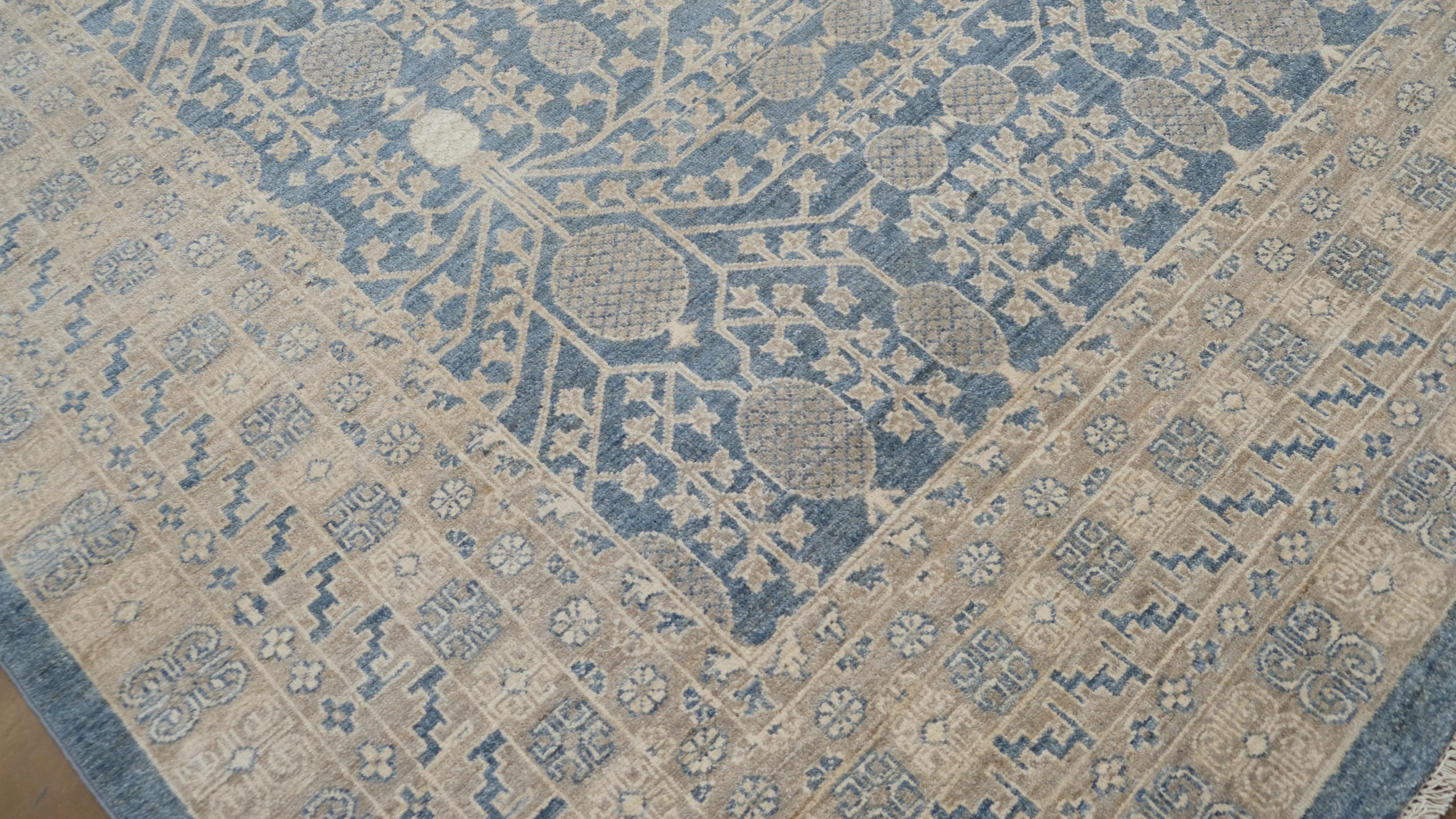  Featuring a captivating  design in a serene palette of blue and ivory, this rug offers a timeless aesthetic that seamlessly blends tradition with modern sophistication. The intricate motifs and detailed border showcase the artistry and meticulous