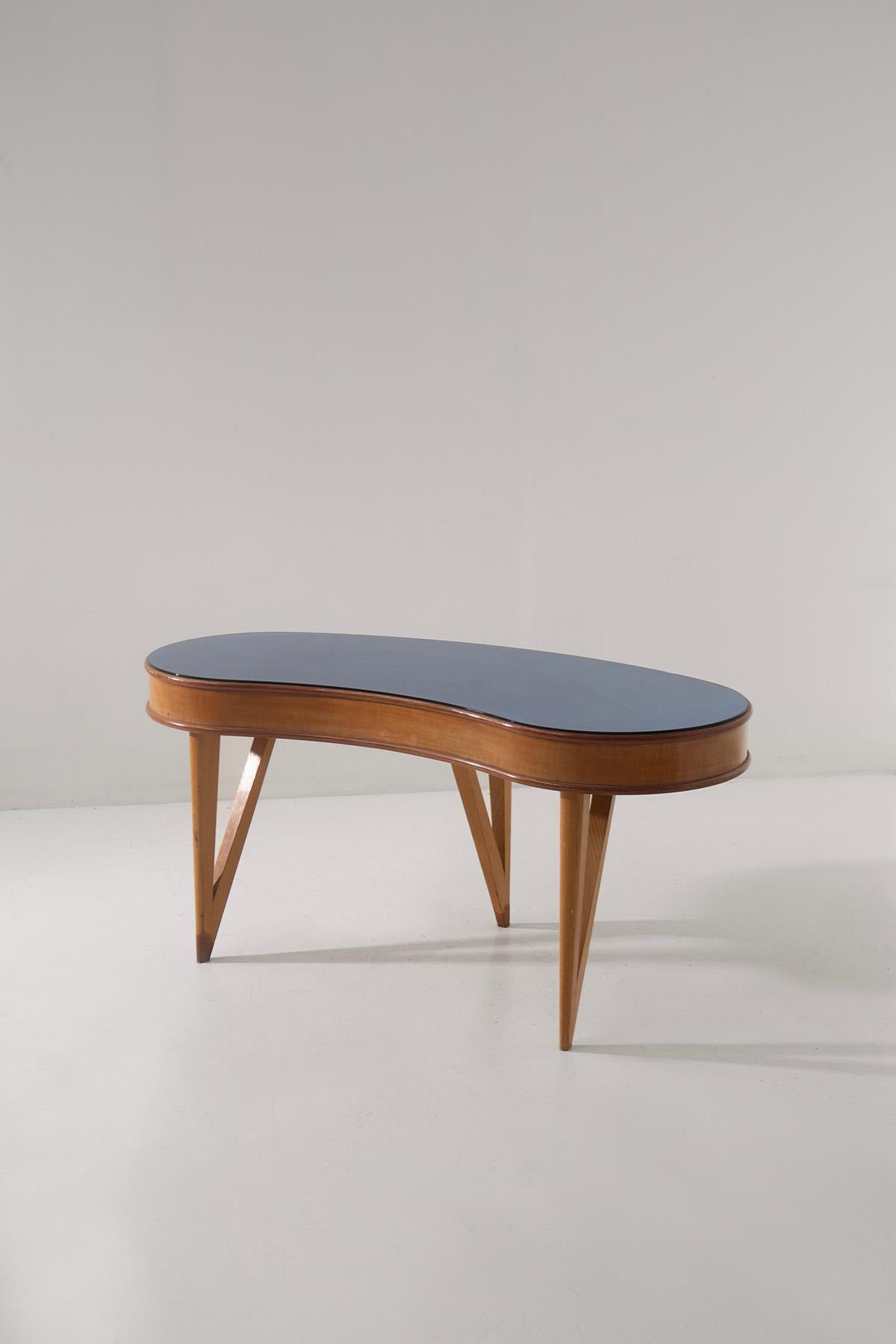 Elegant low console table for bedroom or vanity use from the 1950s, attributed to Fontana Arte for its distinctive shapes and blue mirrored glass base. Made of wood and glass, this console table represents an example of refined and refined design,