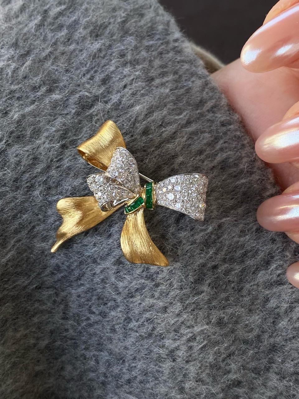 Elegant Gold Bowtie Brooch With Emeralds & Diamonds

Emerald Stone: 0.21ct
Natural Diamond Stone: 1.44ct
Total weight: 6.11grams

This bow-shaped brooch is a paragon of timeless elegance and meticulous craftsmanship. What sets it apart? First, the