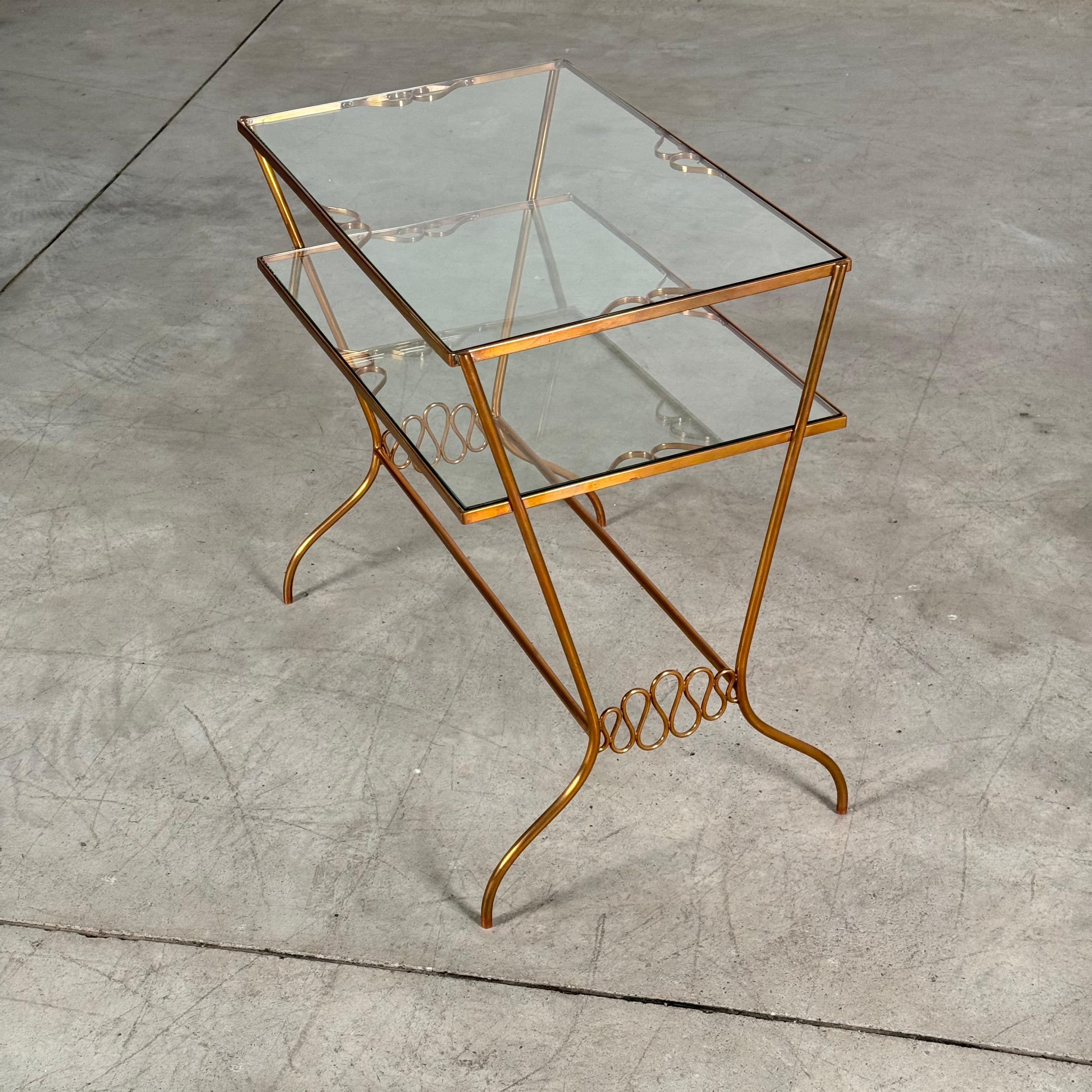 Exceptional and rare bar trolley by Gio Ponti, crafted in brass with two glass shelves. This piece showcases Ponti’s unmistakable design language, highlighted by the elegant nastro pontiano motif — the distinctive ribbon-like loop detail visible on