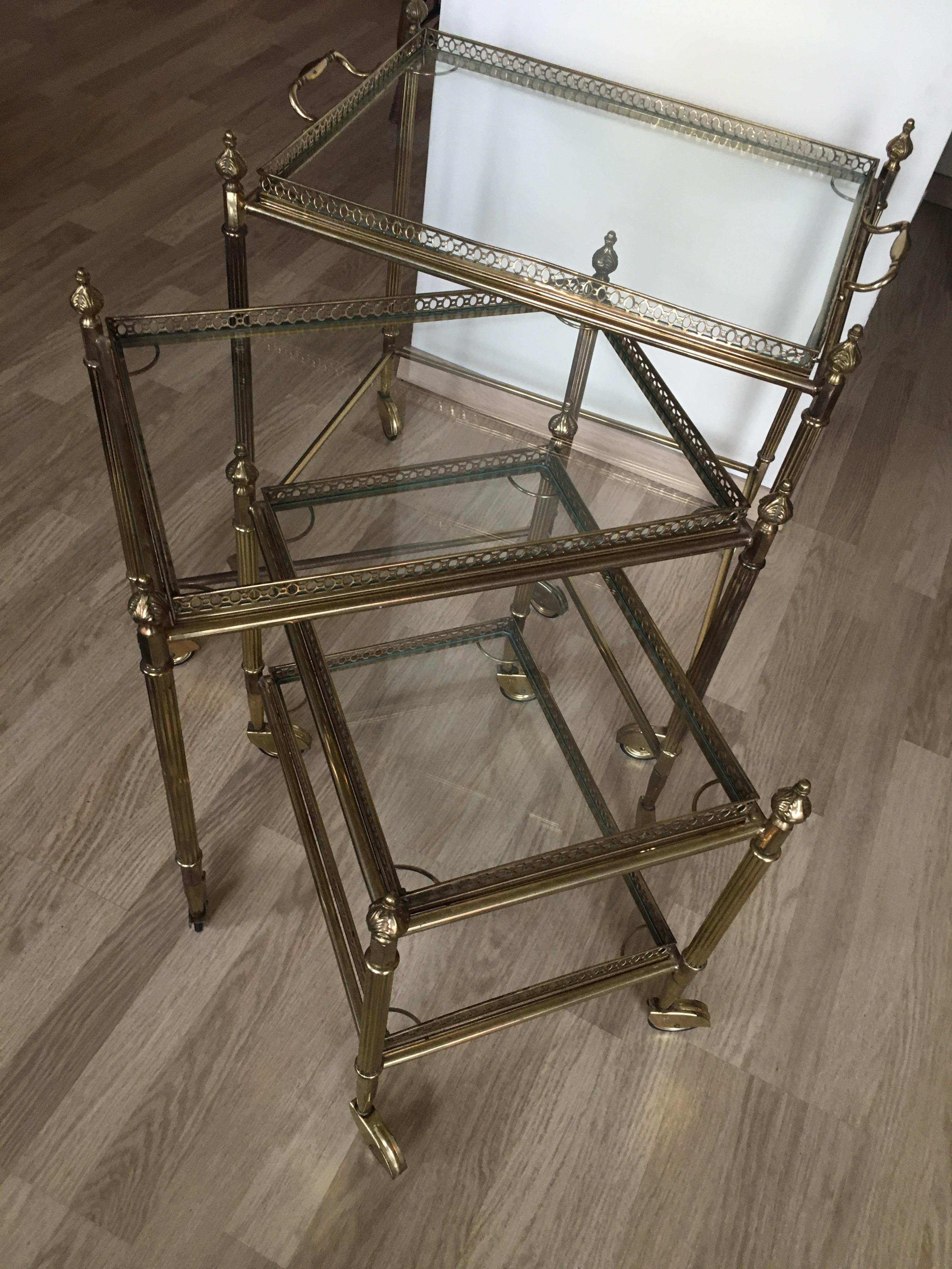 Brass bar cart- nesting tables.
Clear glass tops, one with a serving tray.
Maison Jansen, 1965.