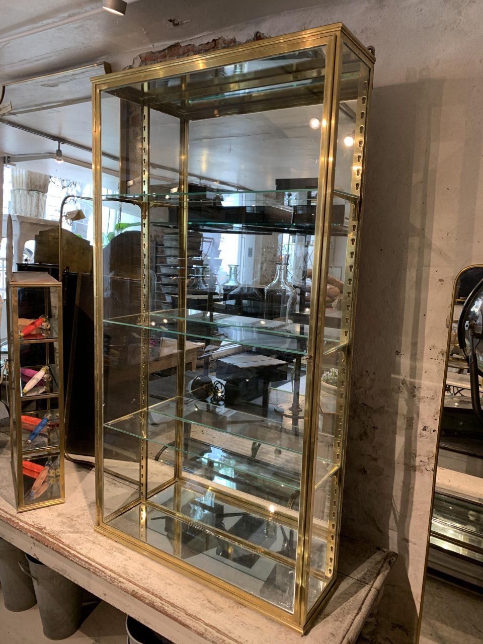Large spacious and handsome old French brass display cabinet, from around the year 1900. Classic Art Nouveau style, which can be seen on the quality brass shelf brackets. This lovely wall vitrine is equipped with an impressive large glass door with