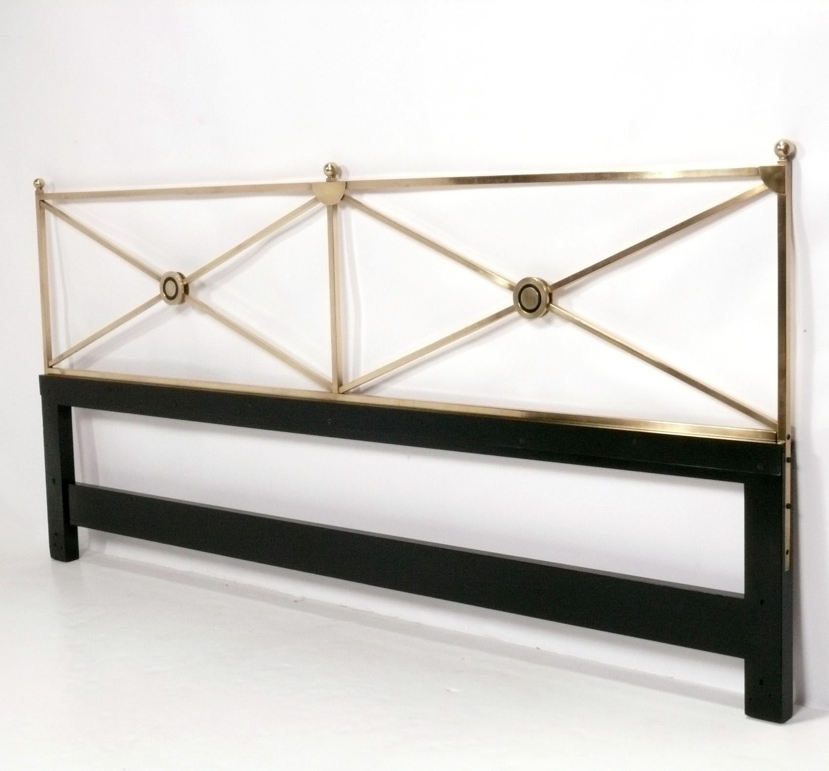 Elegant Brass X Form King Size Headboard by Baker, signed, American, circa 1960s. The brass has been hand polished and lacquered and the wood base repainted black at some point. It can be used with a king size mattress with a standard Hollywood