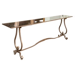 Élégante table console en fer finition bronze avec plateau en miroir tacheté