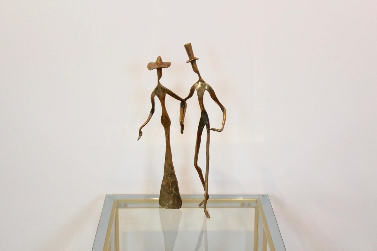 A truly eye-catching, unusual bronze sculpture of a couple holding hands tenderly. Very elegant and beautifully styled with nice patin. Produced circa 1970s in Belgium. One of a kind and in excellent condition. The piece is signed but not readable