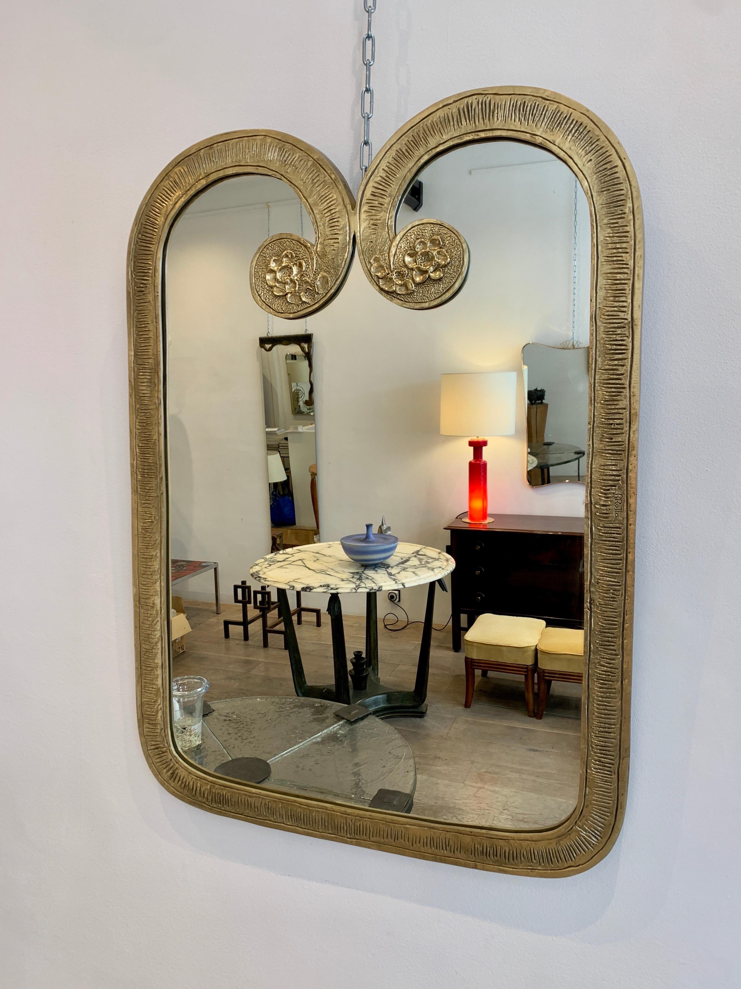 Angelo Brotto is a famous Italian designer, who specialized in lights and wall decoration. This mirror, which is signed, is a rare piece and quite elegant. It unites artistic creation and decorative qualities. 