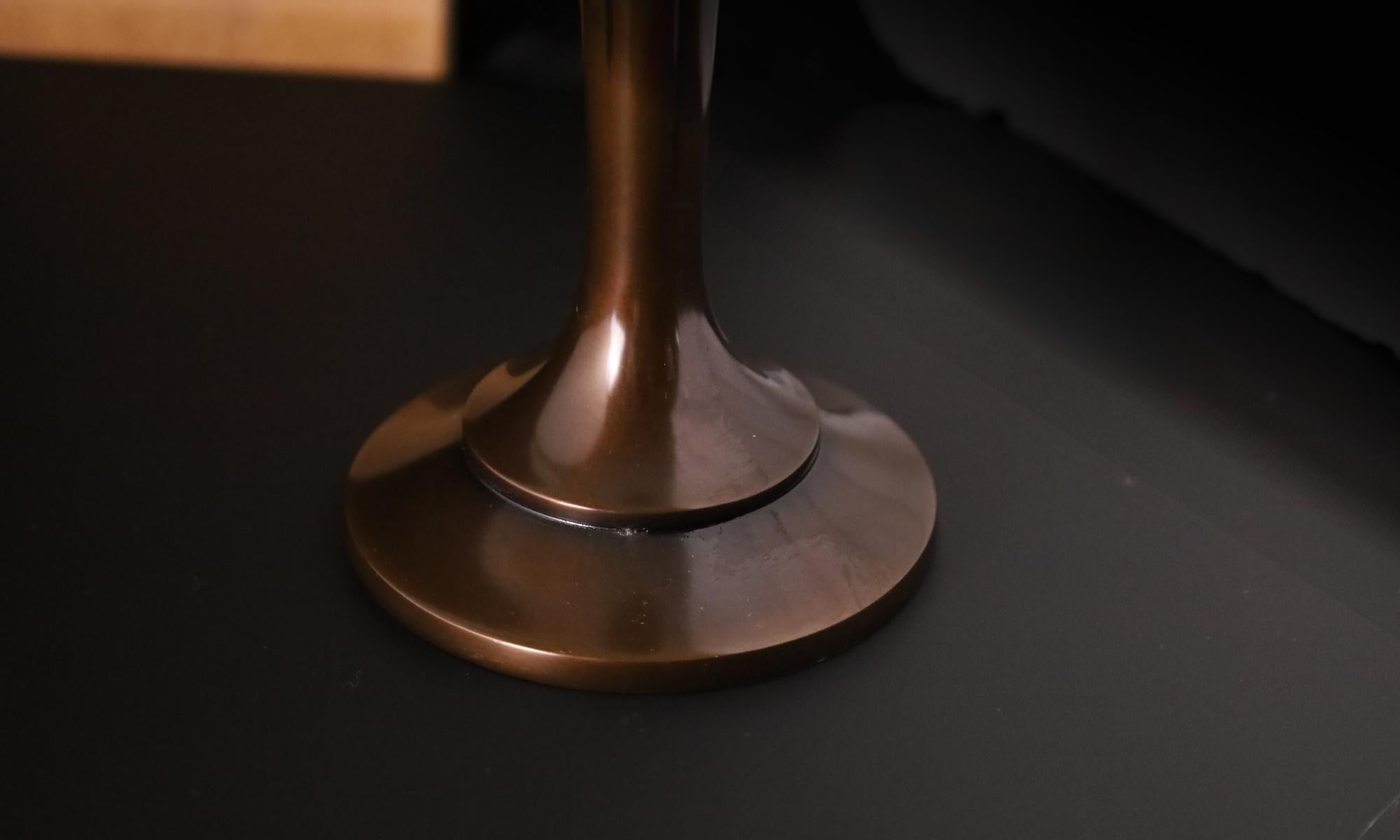 Uno squisito vaso monofiore giapponese in bronzo (Ichirin-ike) del rinomato artigiano Asano Norio (浅野紀夫), membro a pieno titolo della Nihon Kogeikai (Japan Traditional Crafts Association). Questo elegante vaso presenta un raffinato motivo a linee